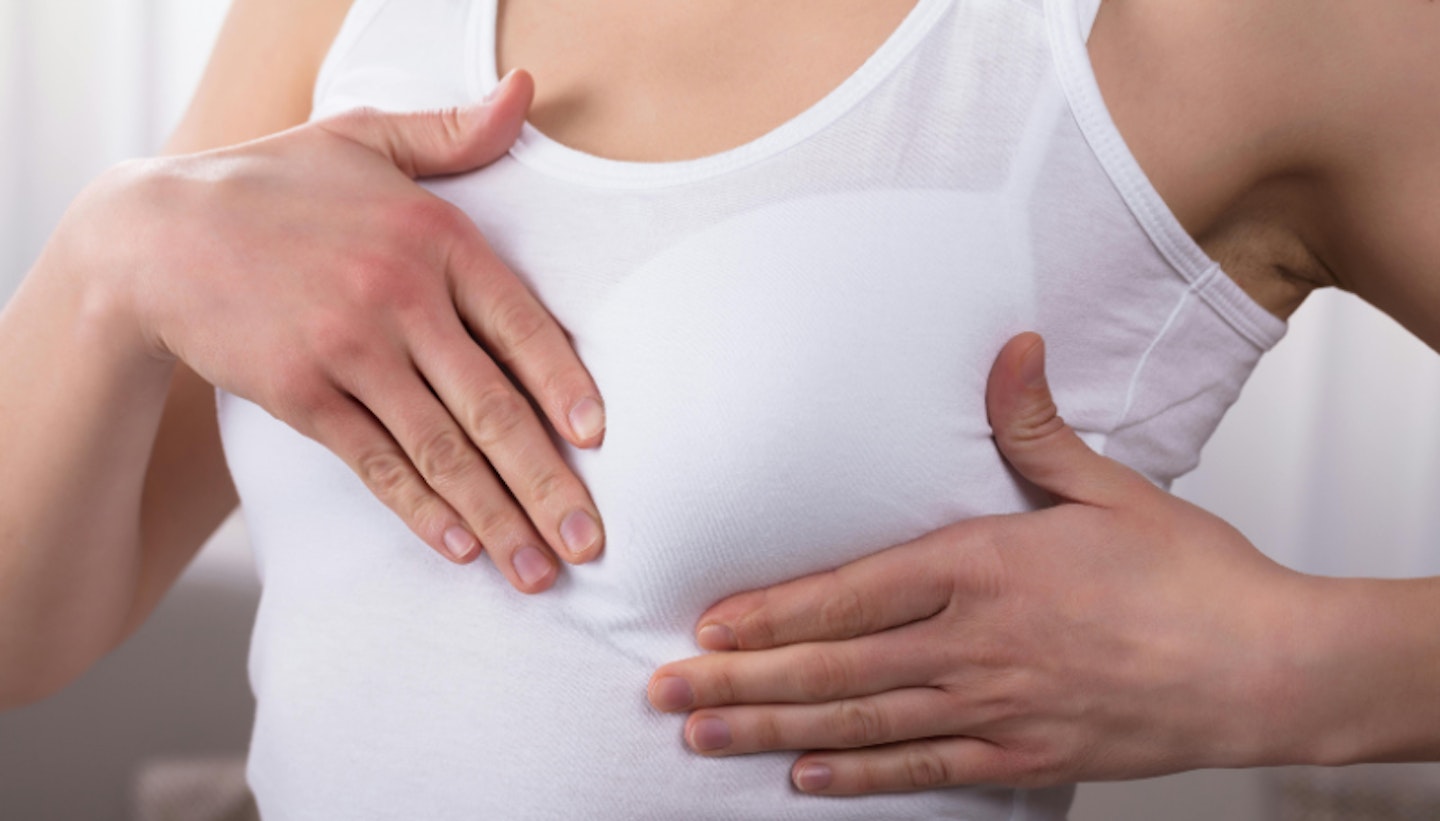 woman checking breasts