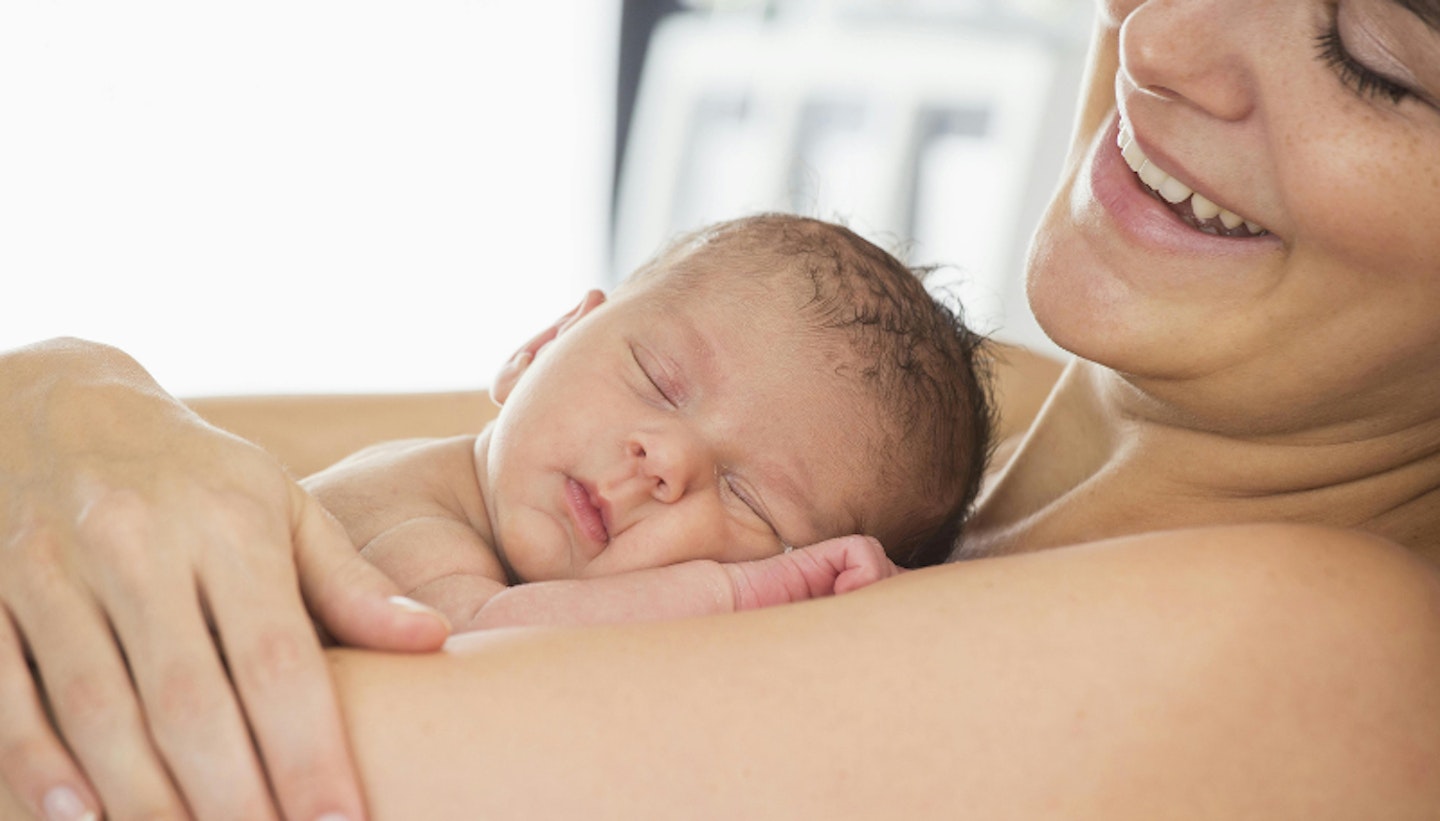 woman holding newborn baby