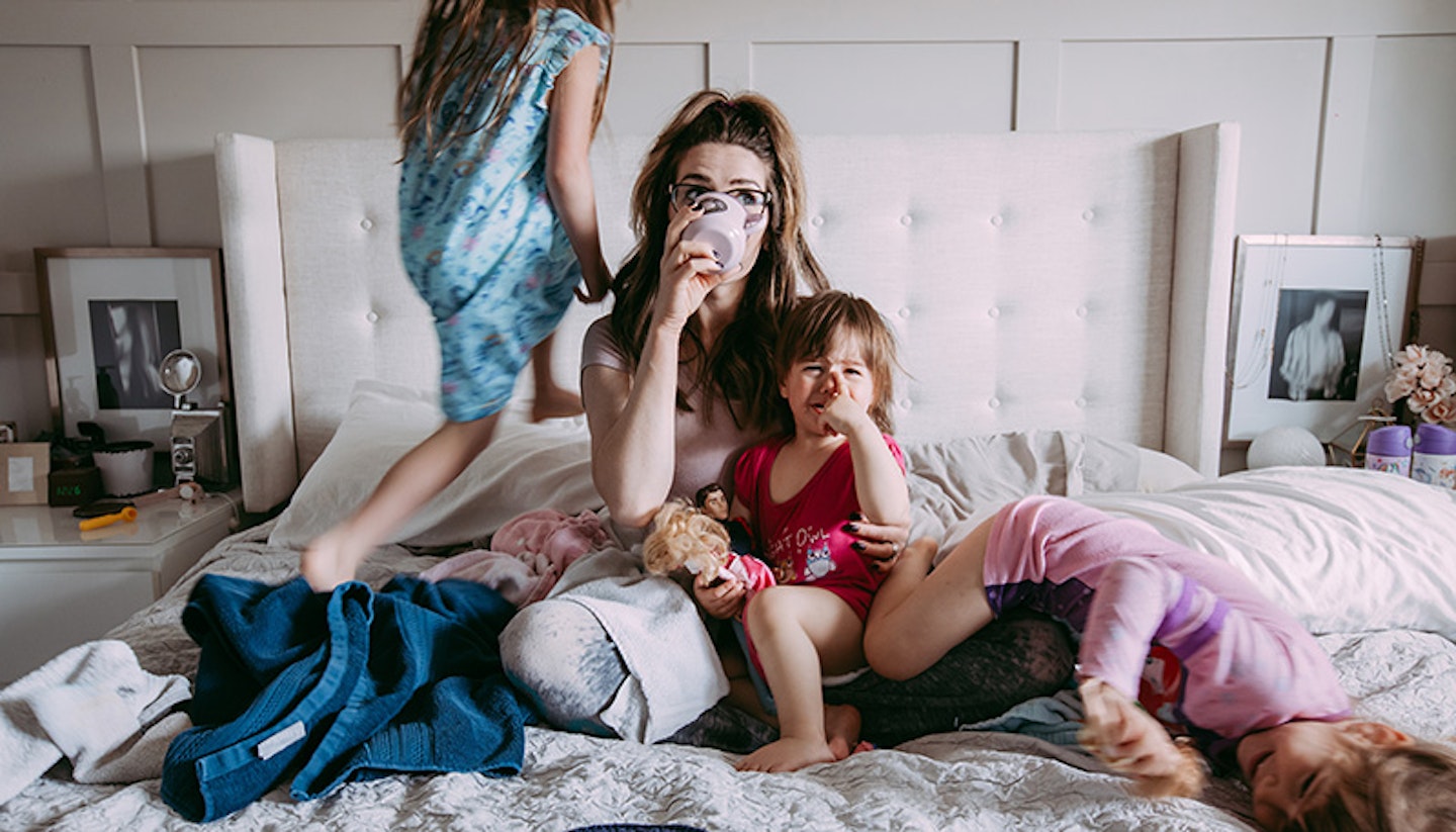 A woman surrounded by children and the mental load