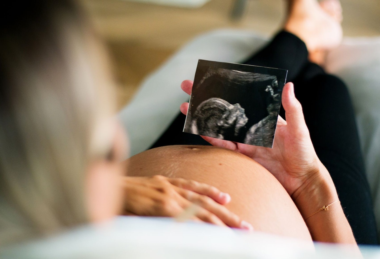 Pregnant Woman Holding an Ultra Sound Picture of Unborn Child