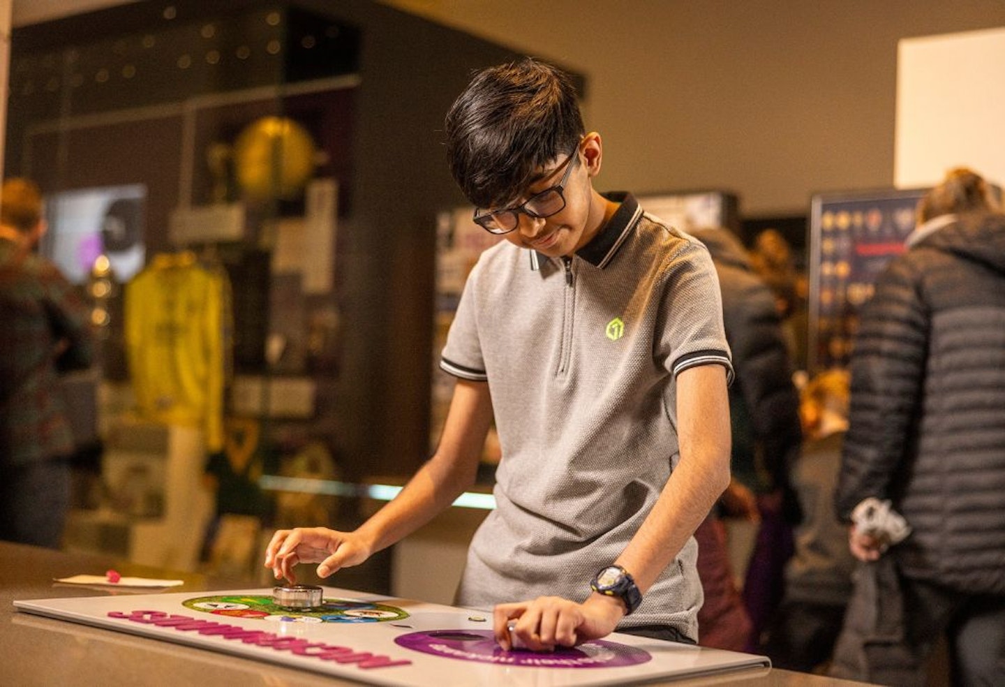 Young boy playing with one of the exhibits at the National Football Museum