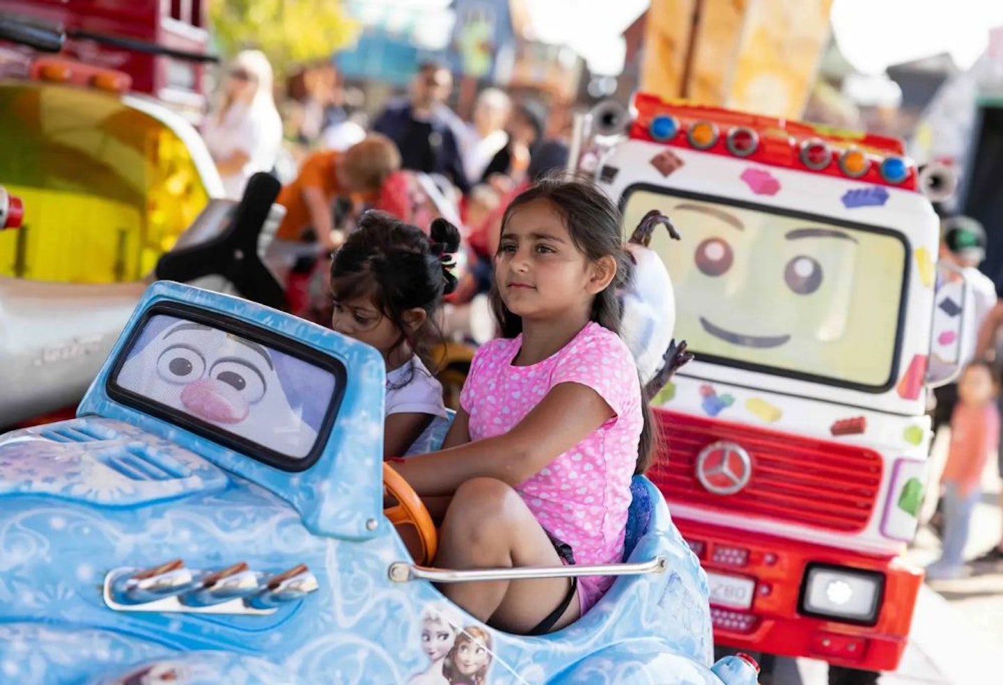 Children riding a car on the merry-go-round at Southport pleasure land