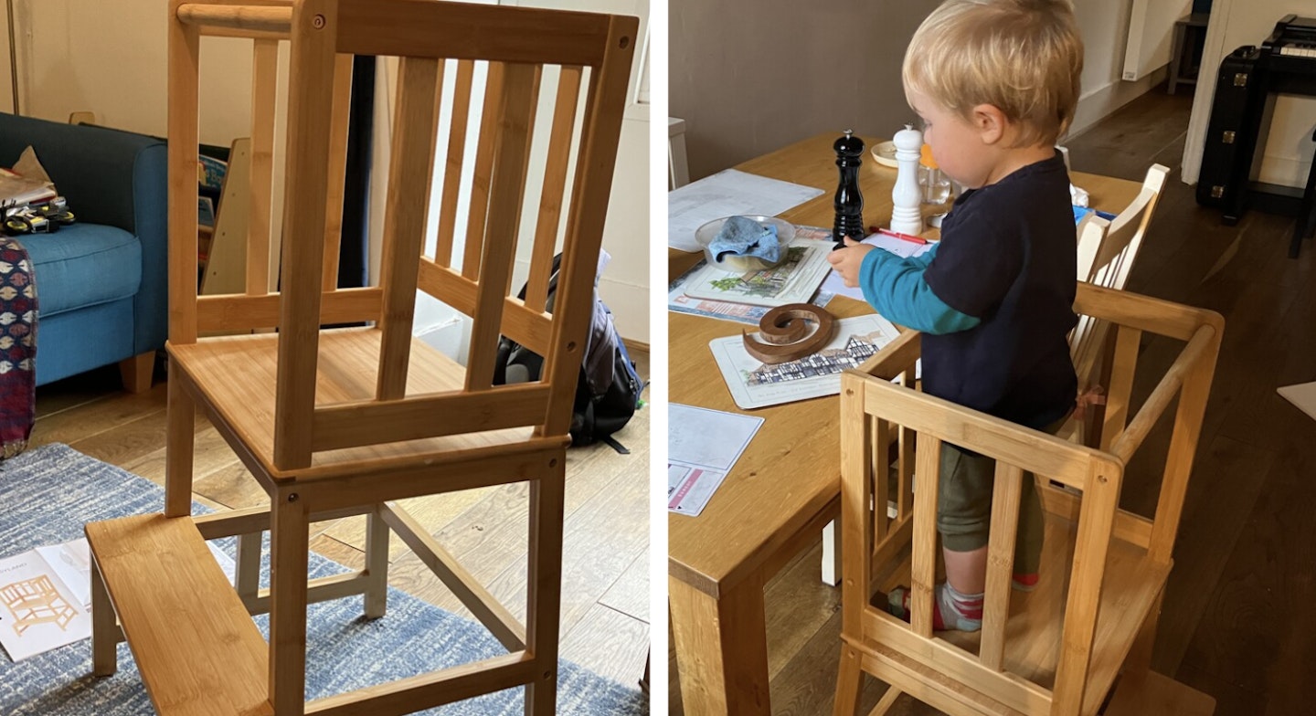 A toddler testing out the COSYLAND Kitchen Kids Standing Tower