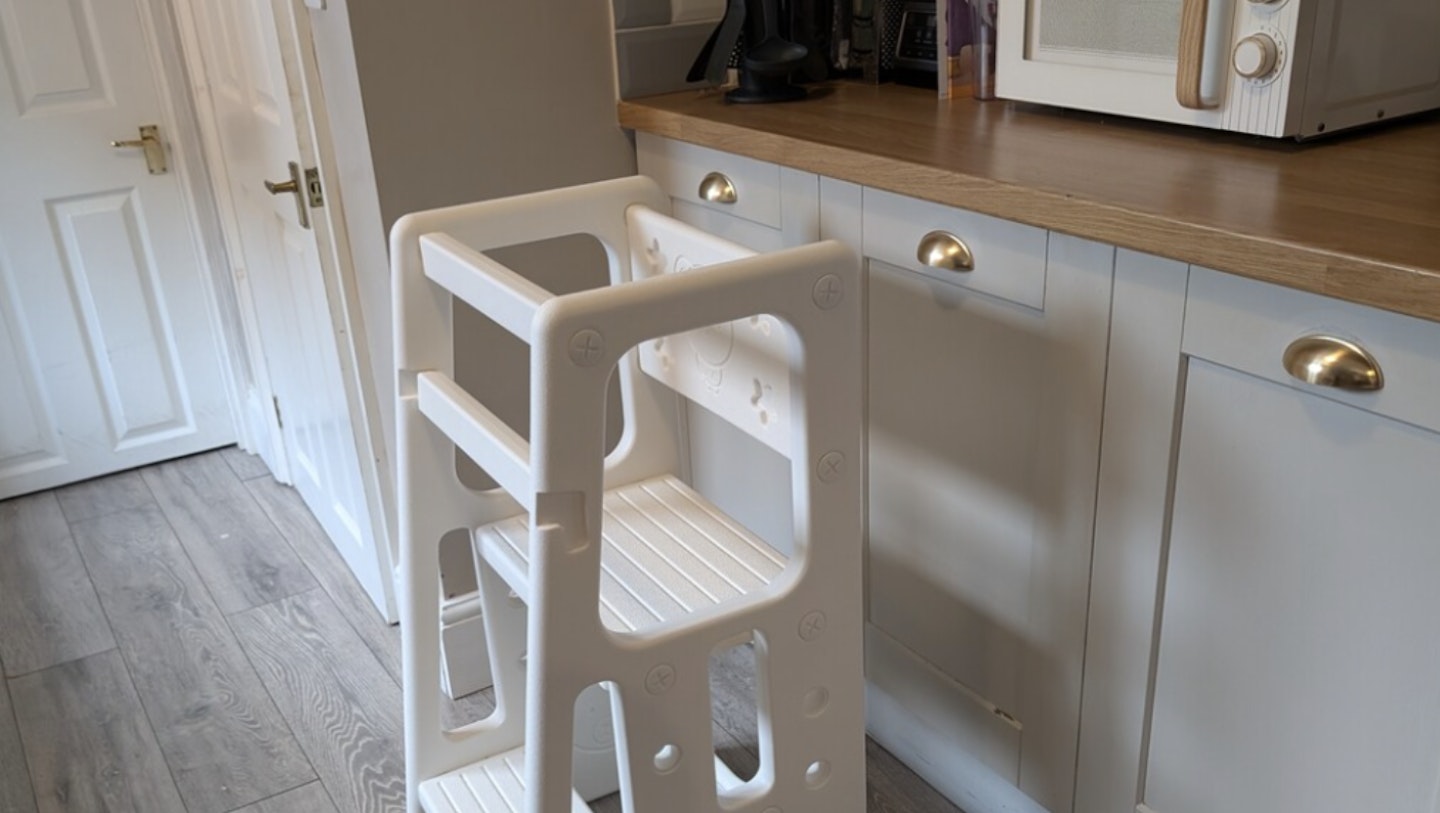 The Homcom toddler standing learning tower built and standing in a kitchen ready 