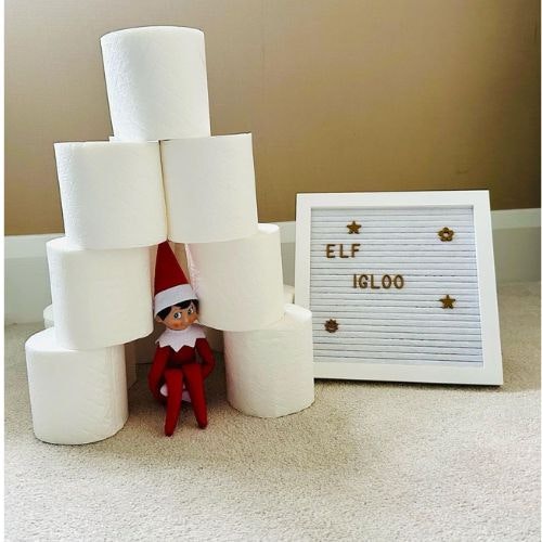 Elf in an igloo madeof toilet rolls