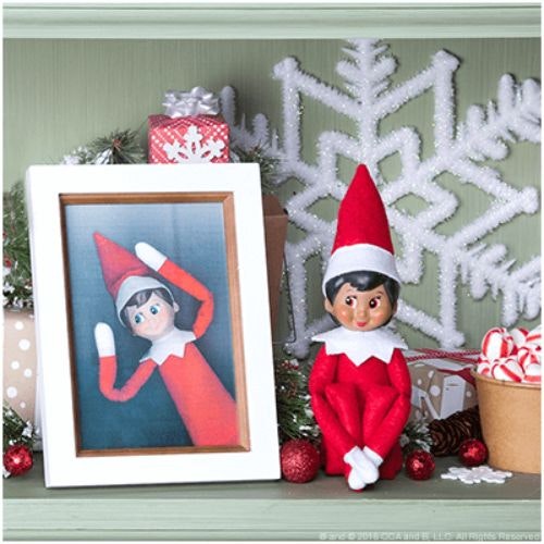 an elf with a photo frame and an elf photo