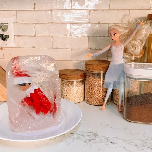 Elsa from Frozen and the elf in a block of ice