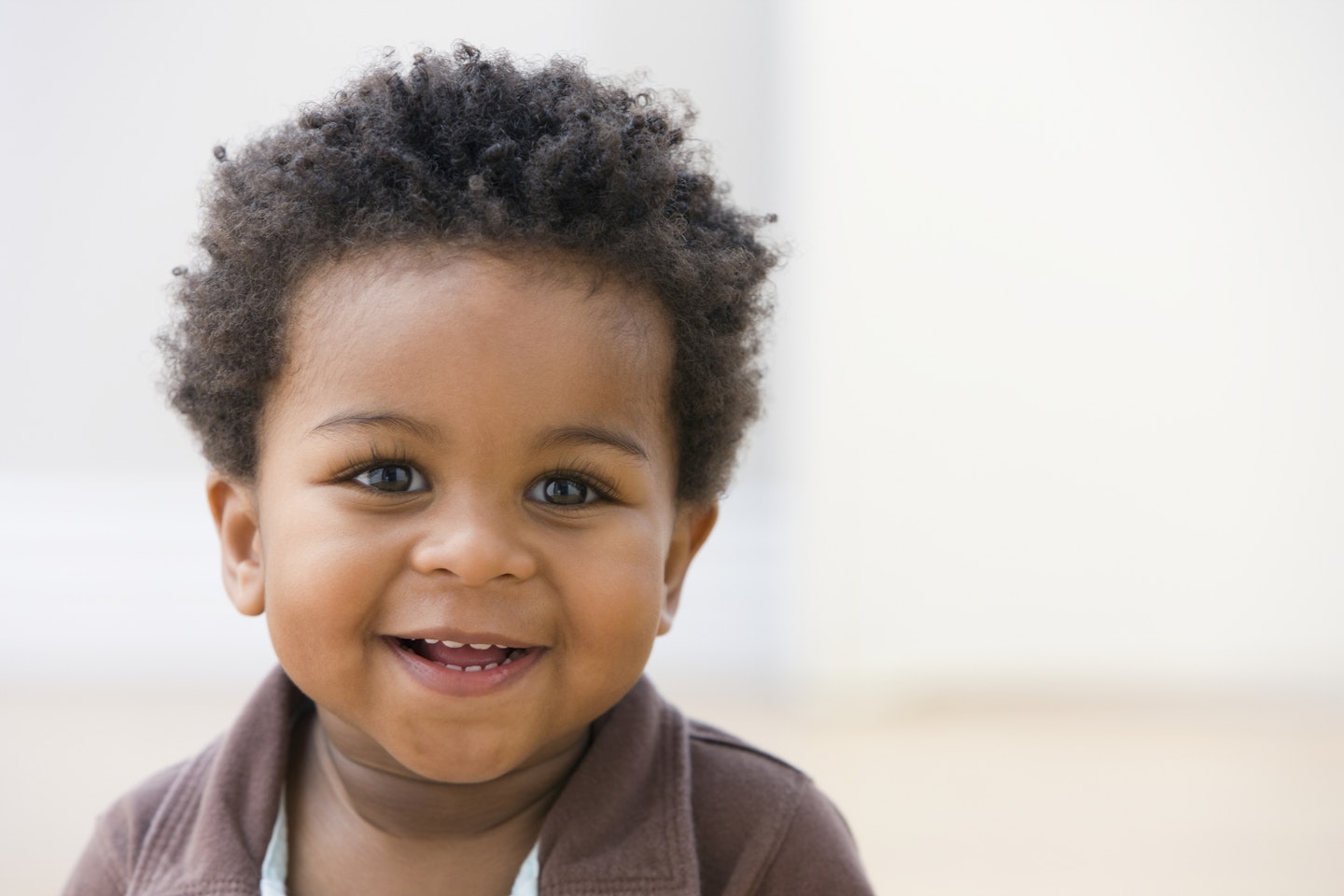 Toddler with afro hair smiling