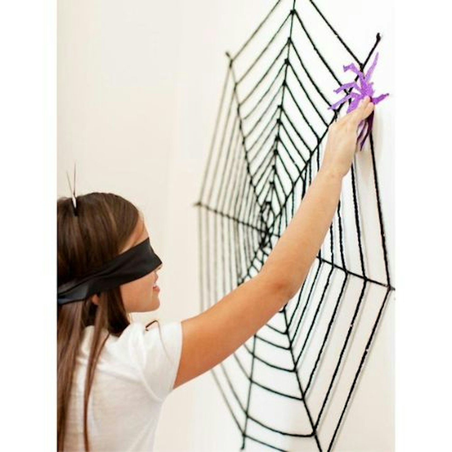 blindfolded girl pinning the spider to the web party game