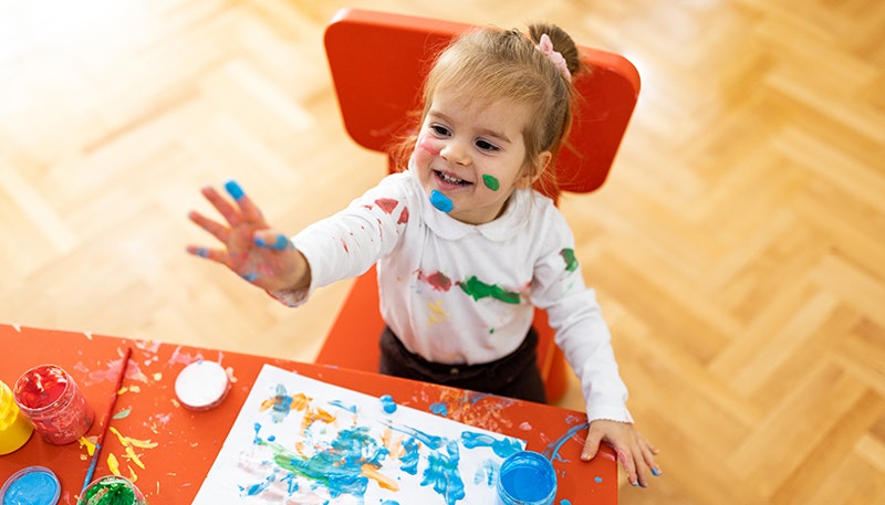 child sitting in toddler table and chair