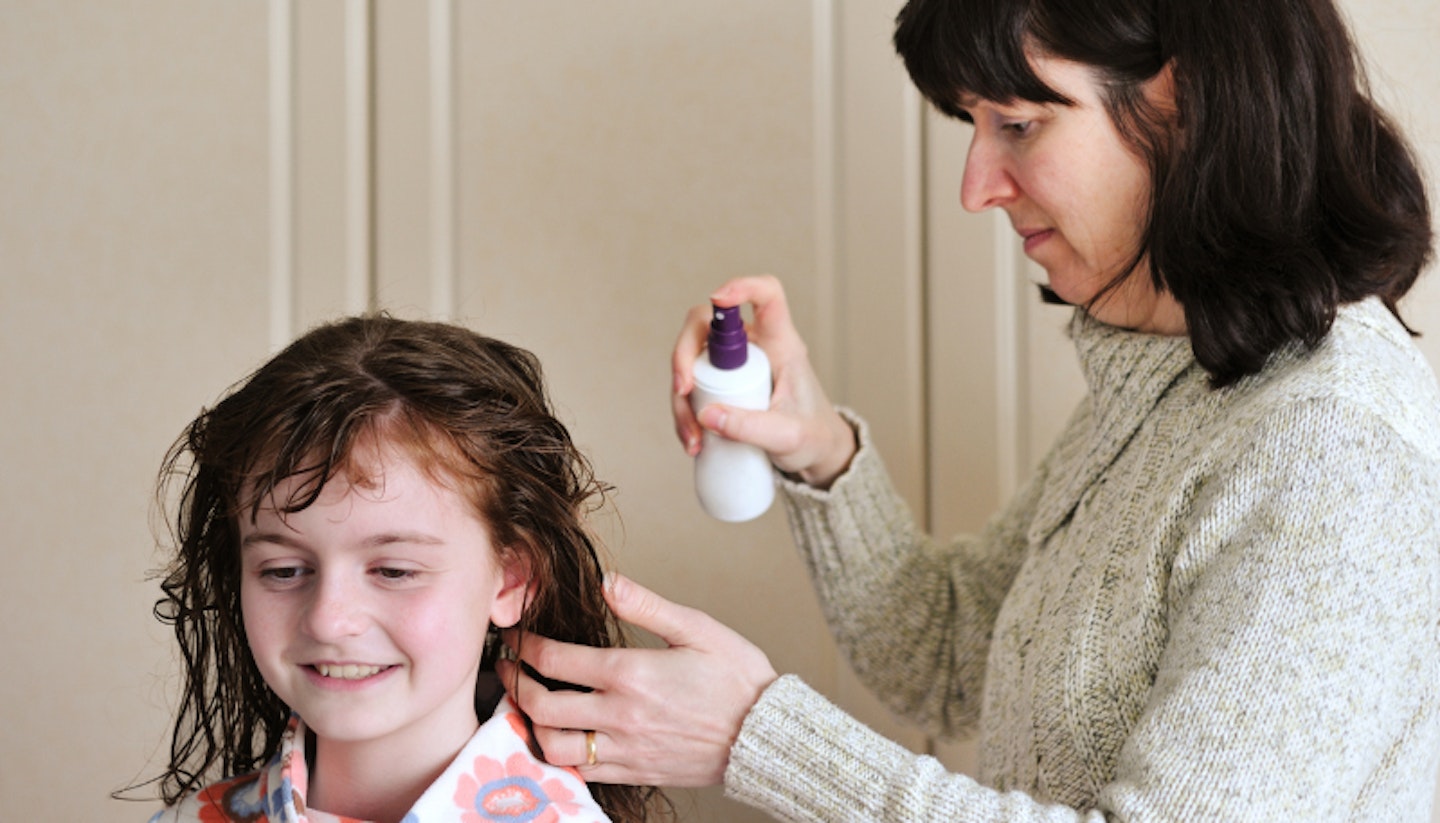 detangling for kids mum spraying daughter's hair