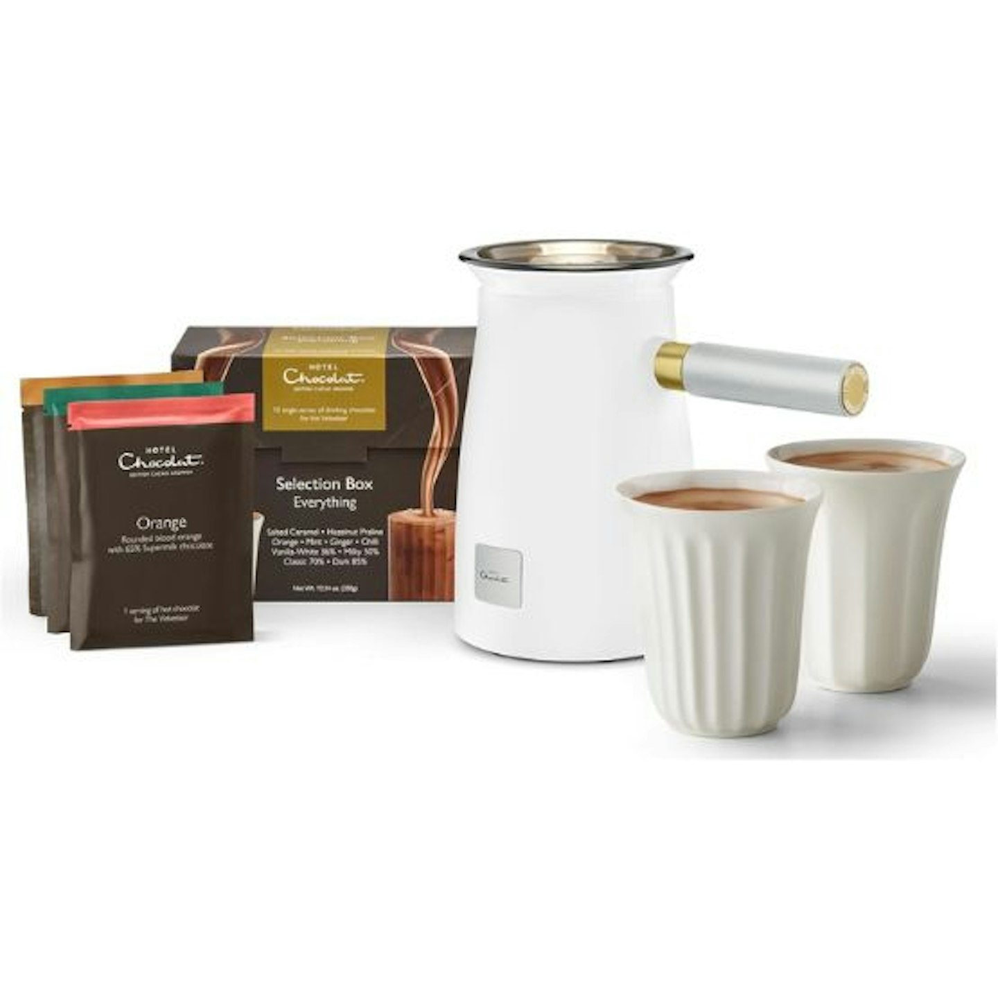 A white Hotel Chocolat Velvetiser and 2 white mugs with a selection of sachets