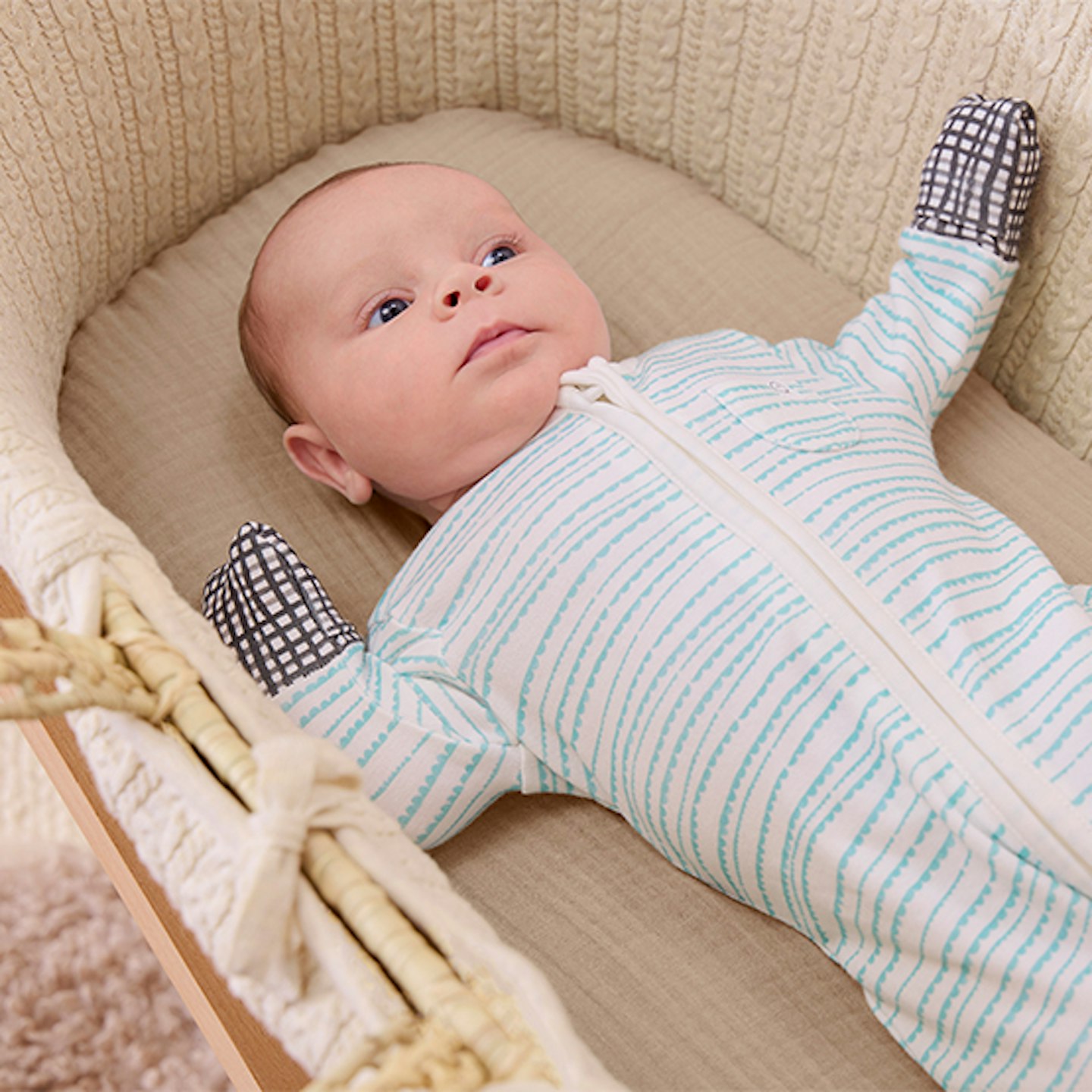 Baby in moses basket wearing MORI x Lovevery Scallop Clever Zip Sleepsuit