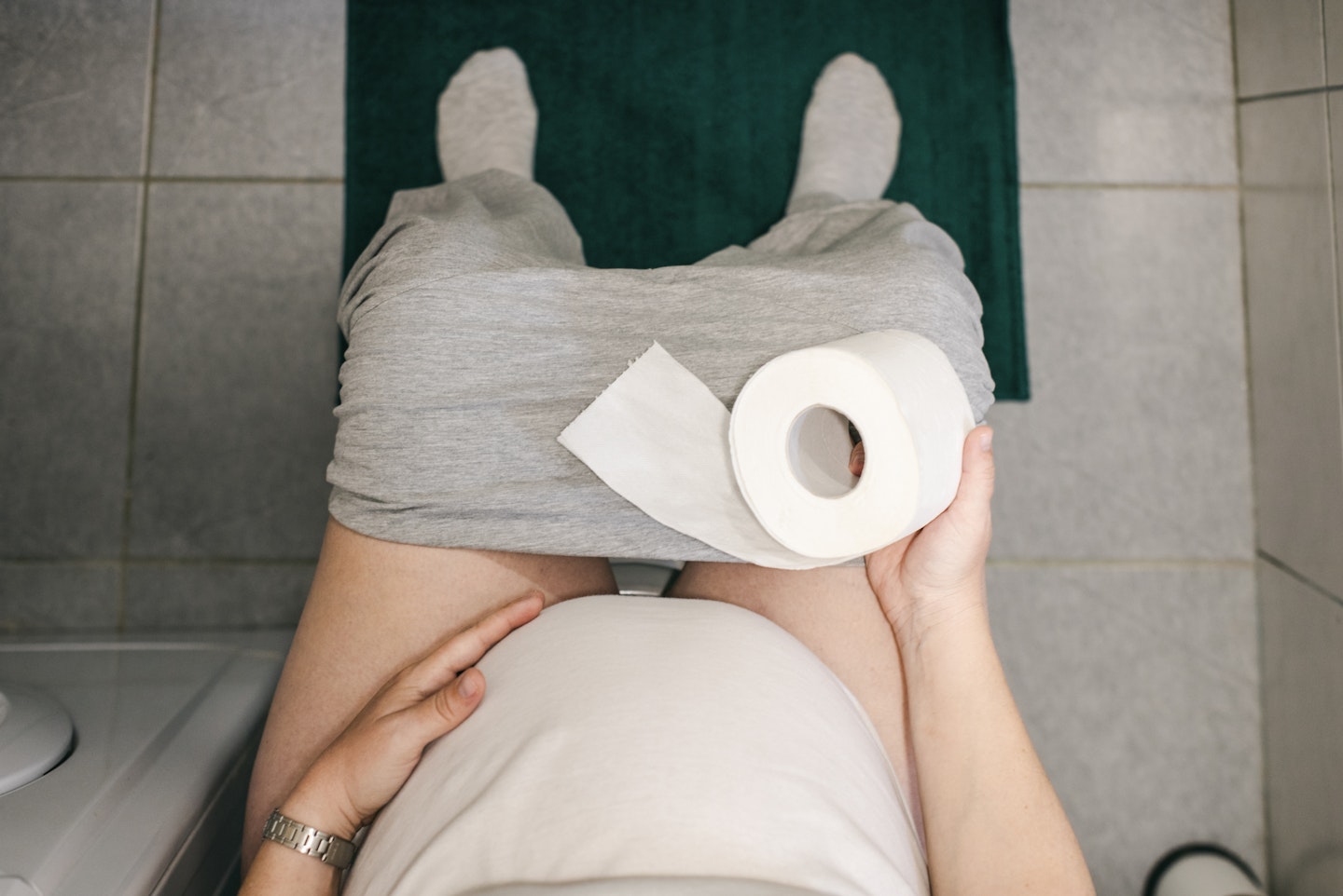 pregnant woman on toilet seat