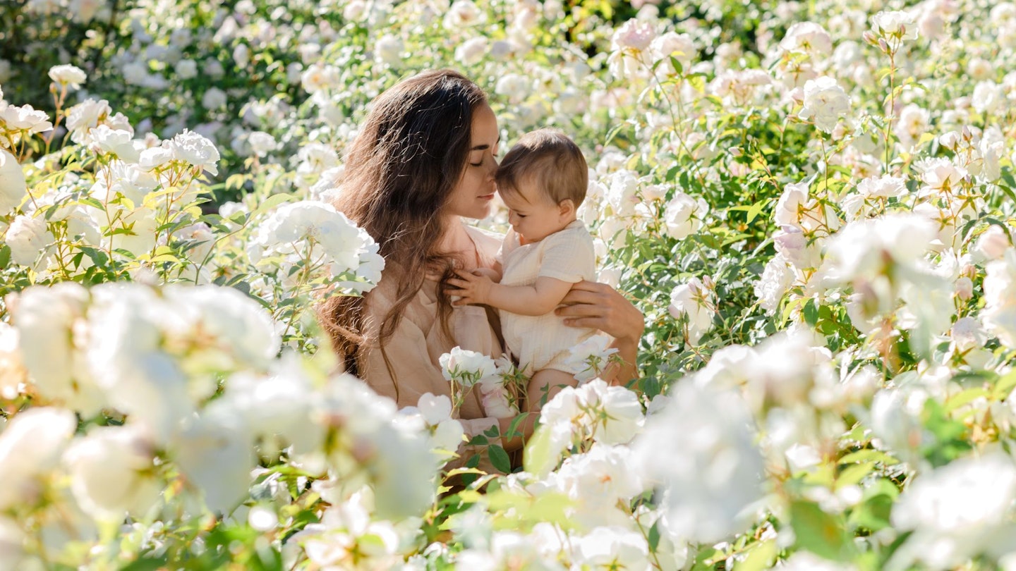 mother and baby in flower fields
