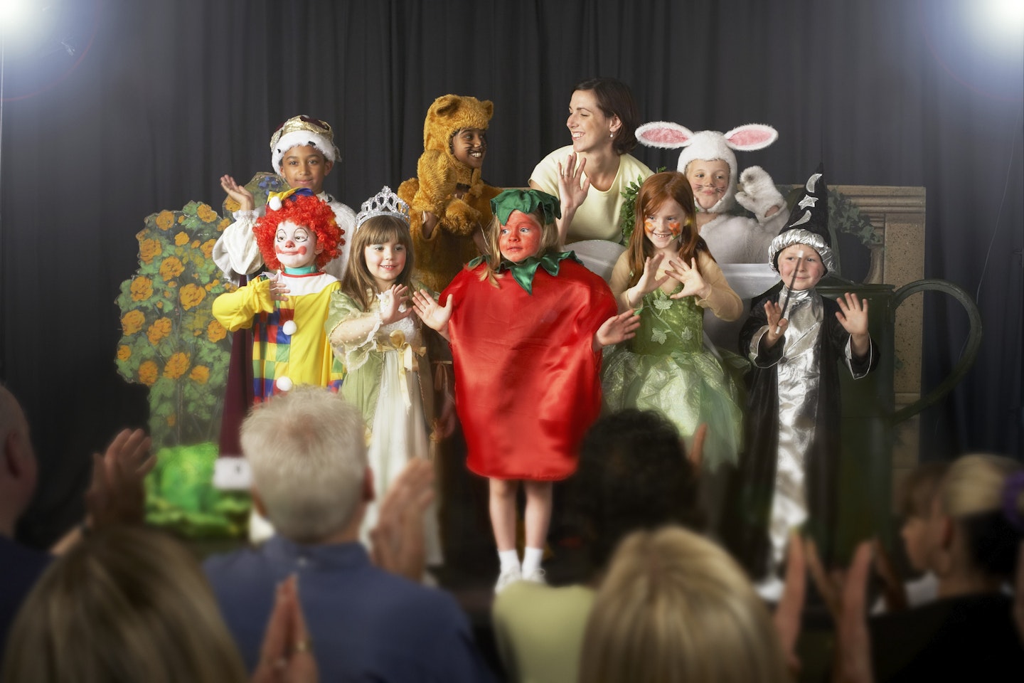 A group of children enjoying a theatre performance.
