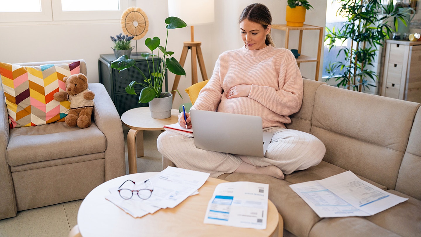 pregnant woman looking at finances