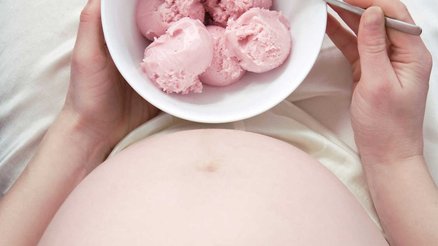 Pregnant woman with bowl of ice cream