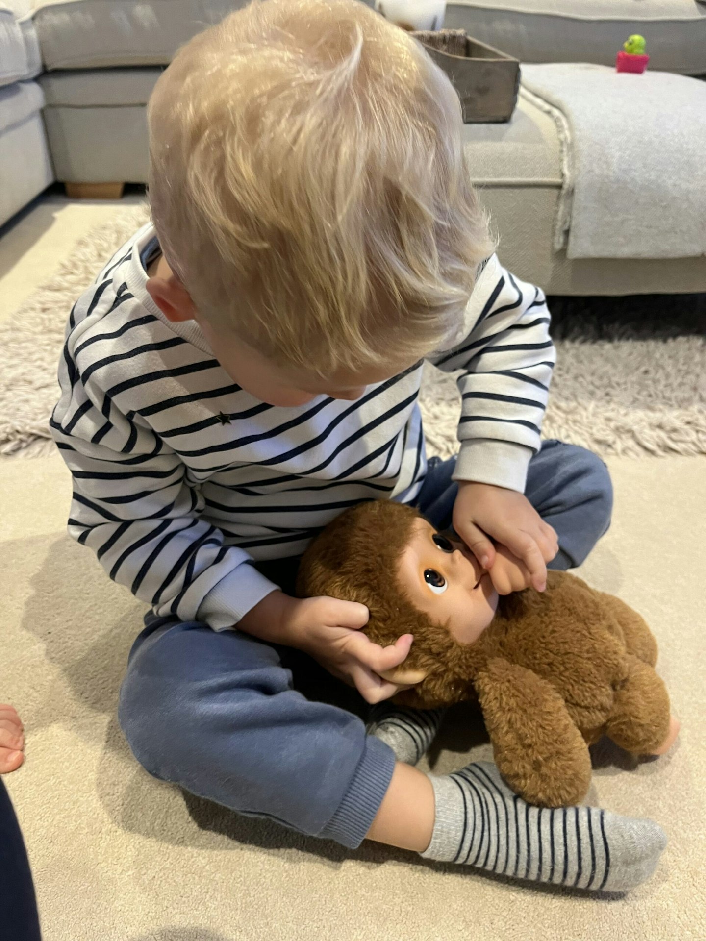 Child playing with Little Live Pets monkey Mango