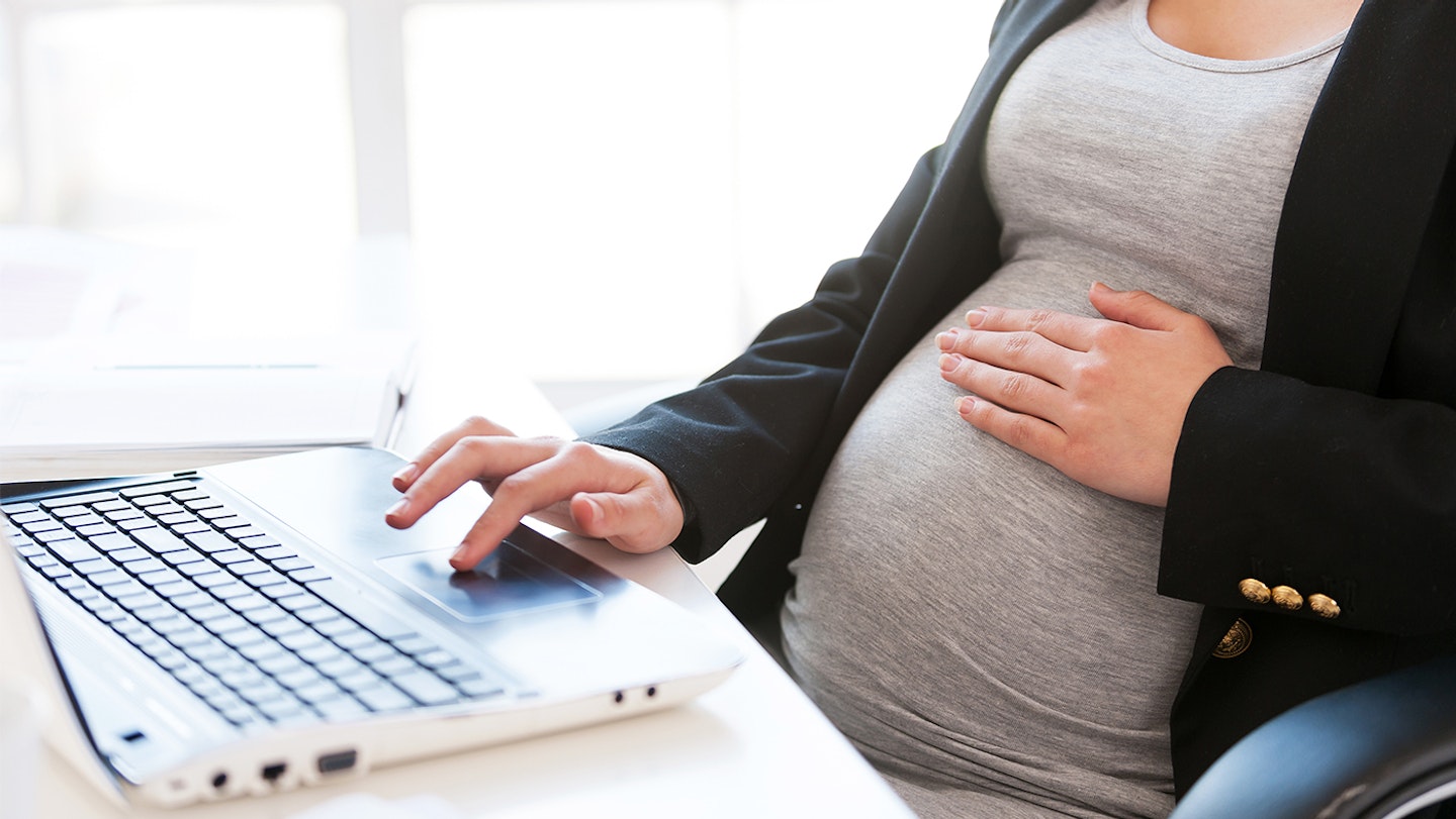 Pregnant woman working on laptop