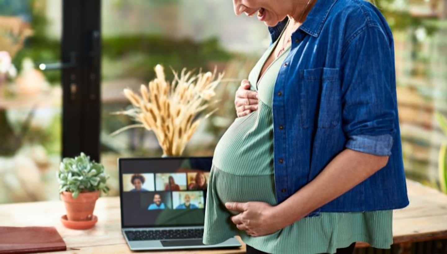 laughing pregnant woman in a Zoom meeting