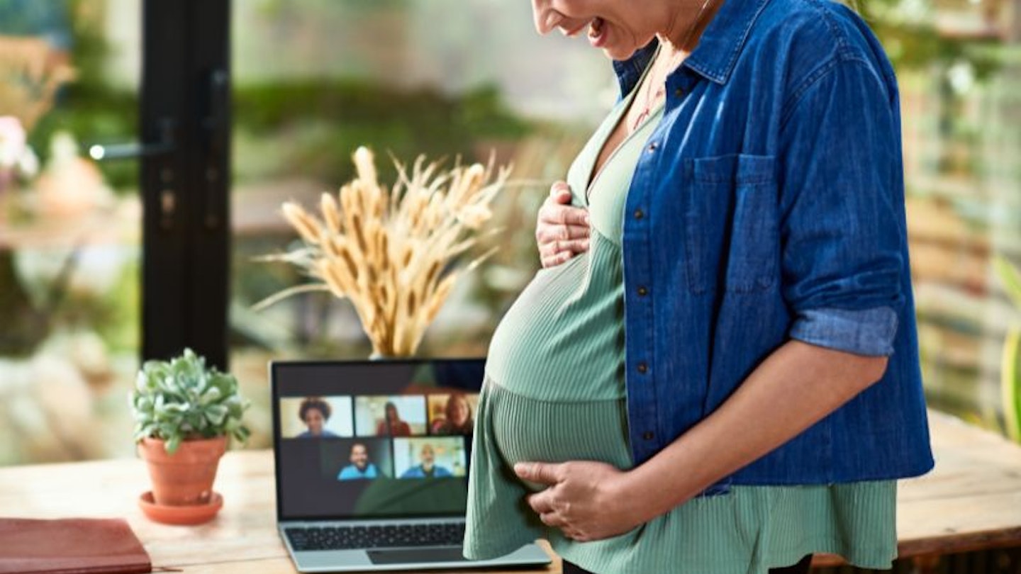 laughing pregnant woman in a Zoom meeting