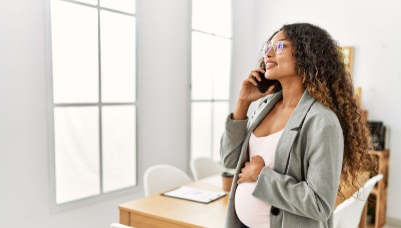 Pregnant woman on the phone in her workplace