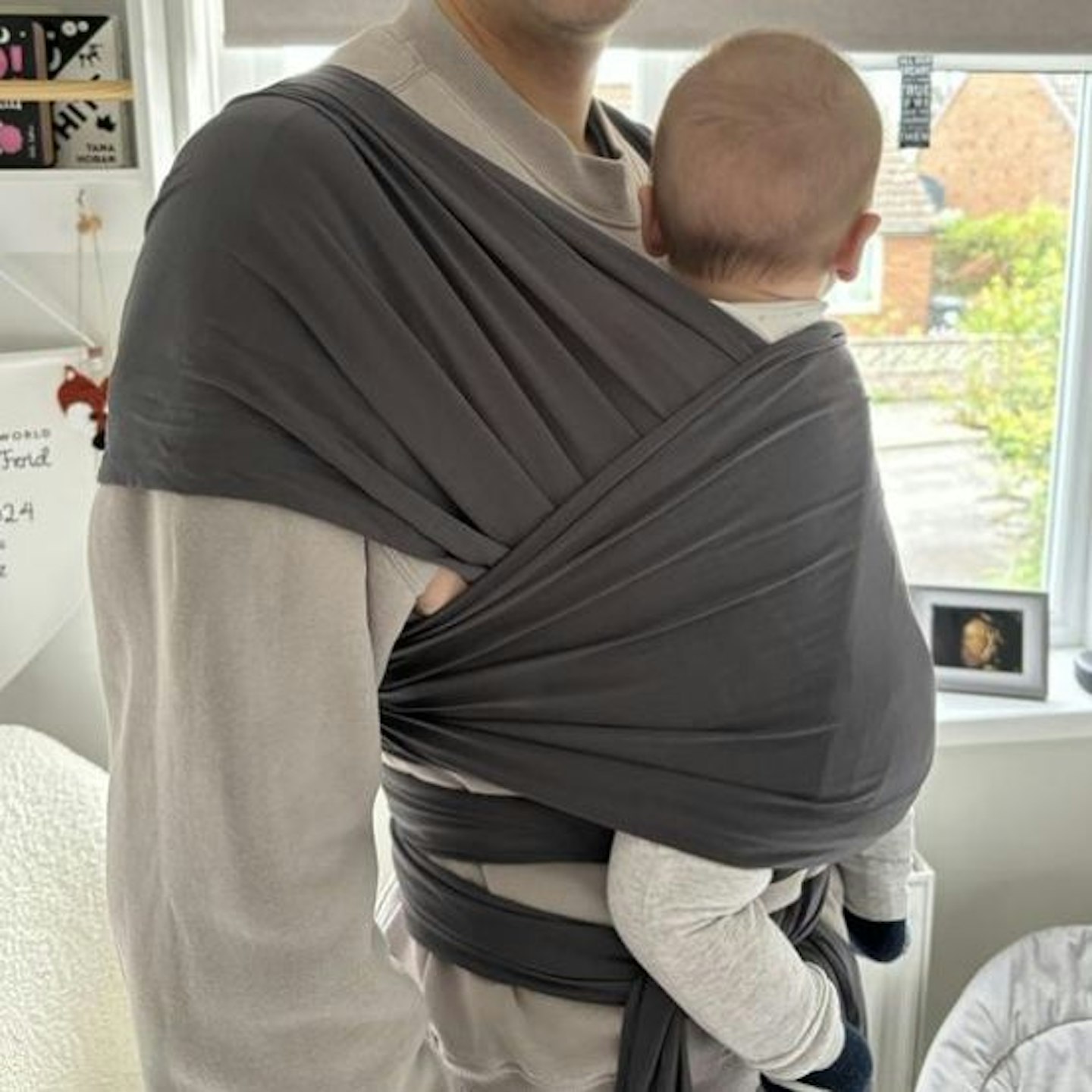 Baby being carried in the Ergobaby Aura Wrap