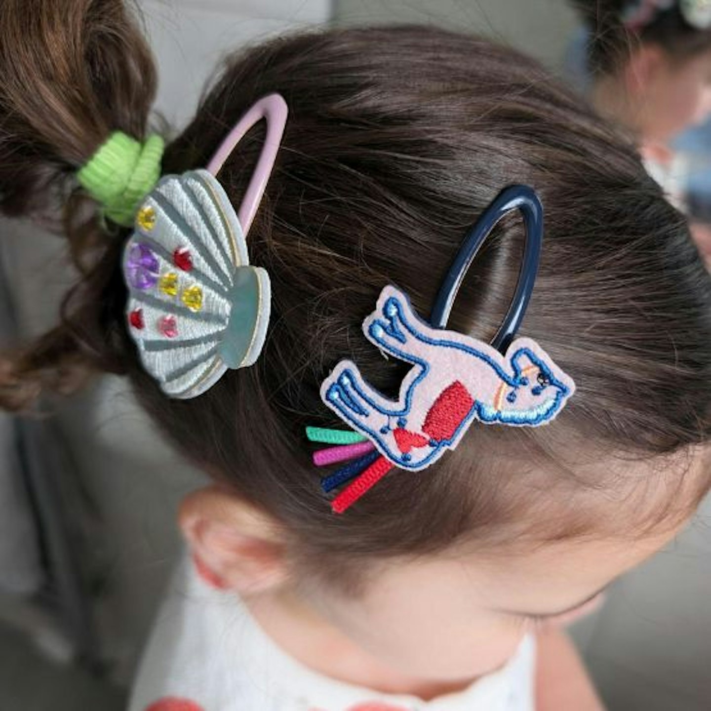 Child wearing the Stych Mermaid Beaded Shell Hair Clips
