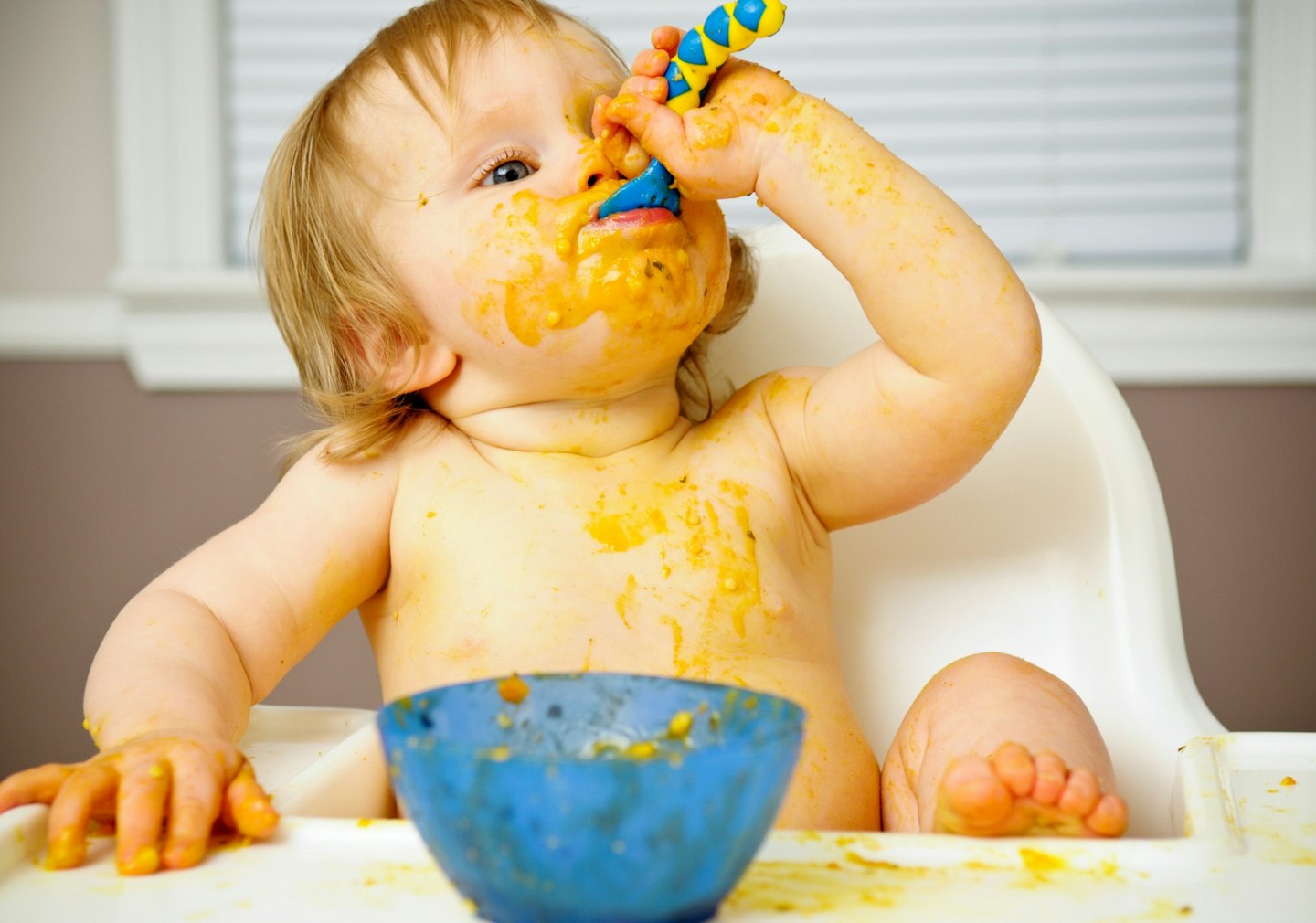 Messy Baby Eating Food in High Chair⁠