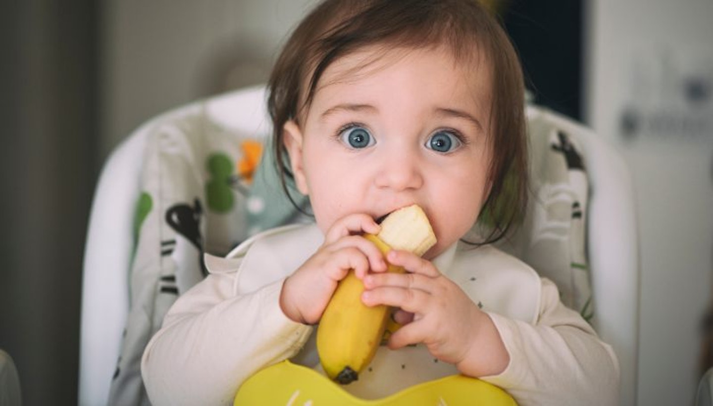 Baby eating banana