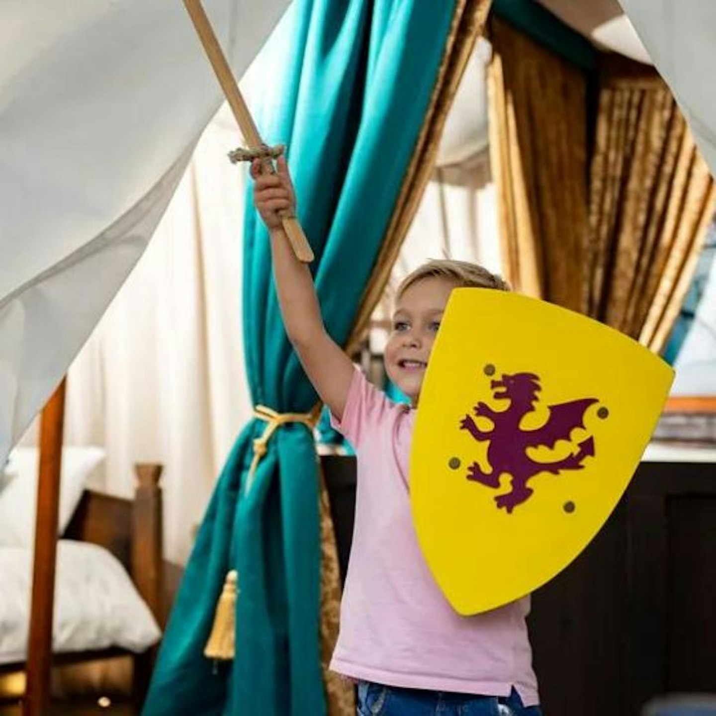 Little girl pretending to be a knight at Warwick Castle Knight's Village Glamping