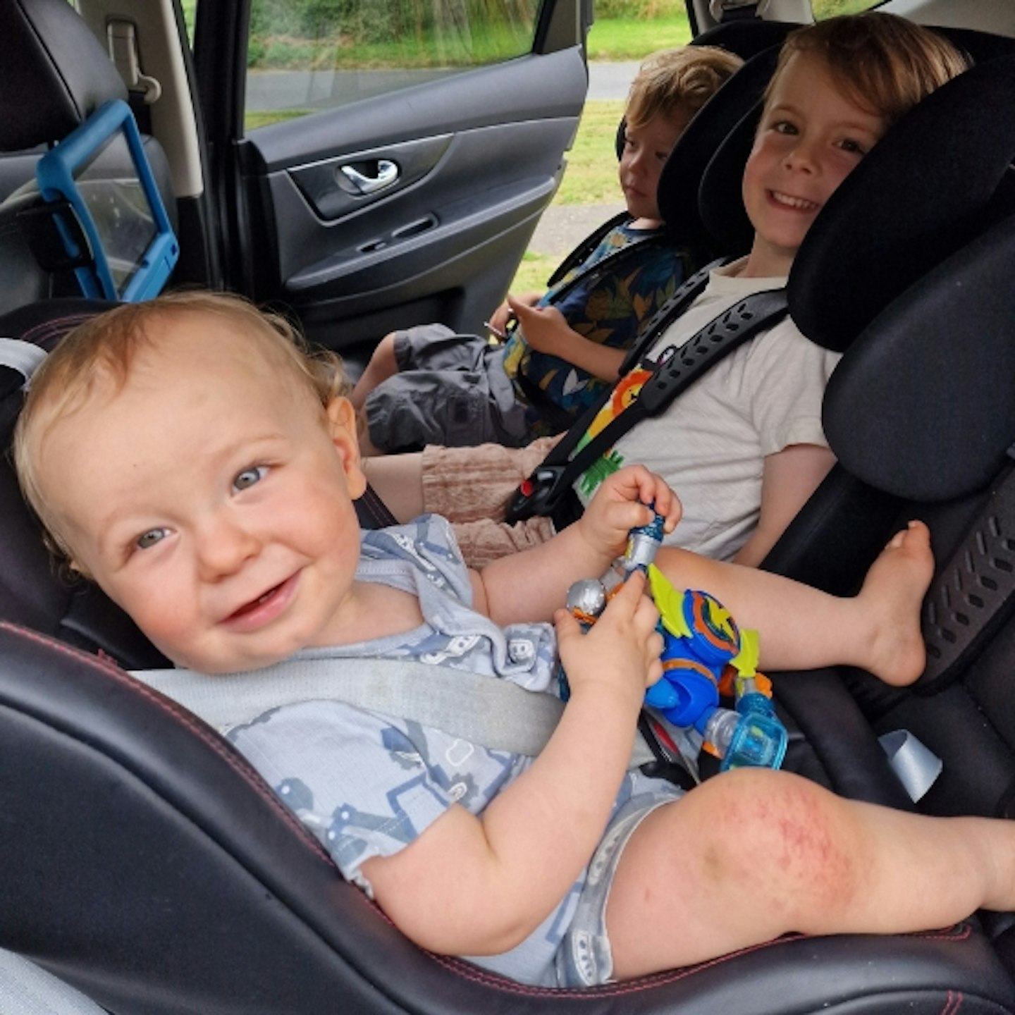 all three young children in the back of a car in the Multimac Three Seater Car Seat, and Minimac