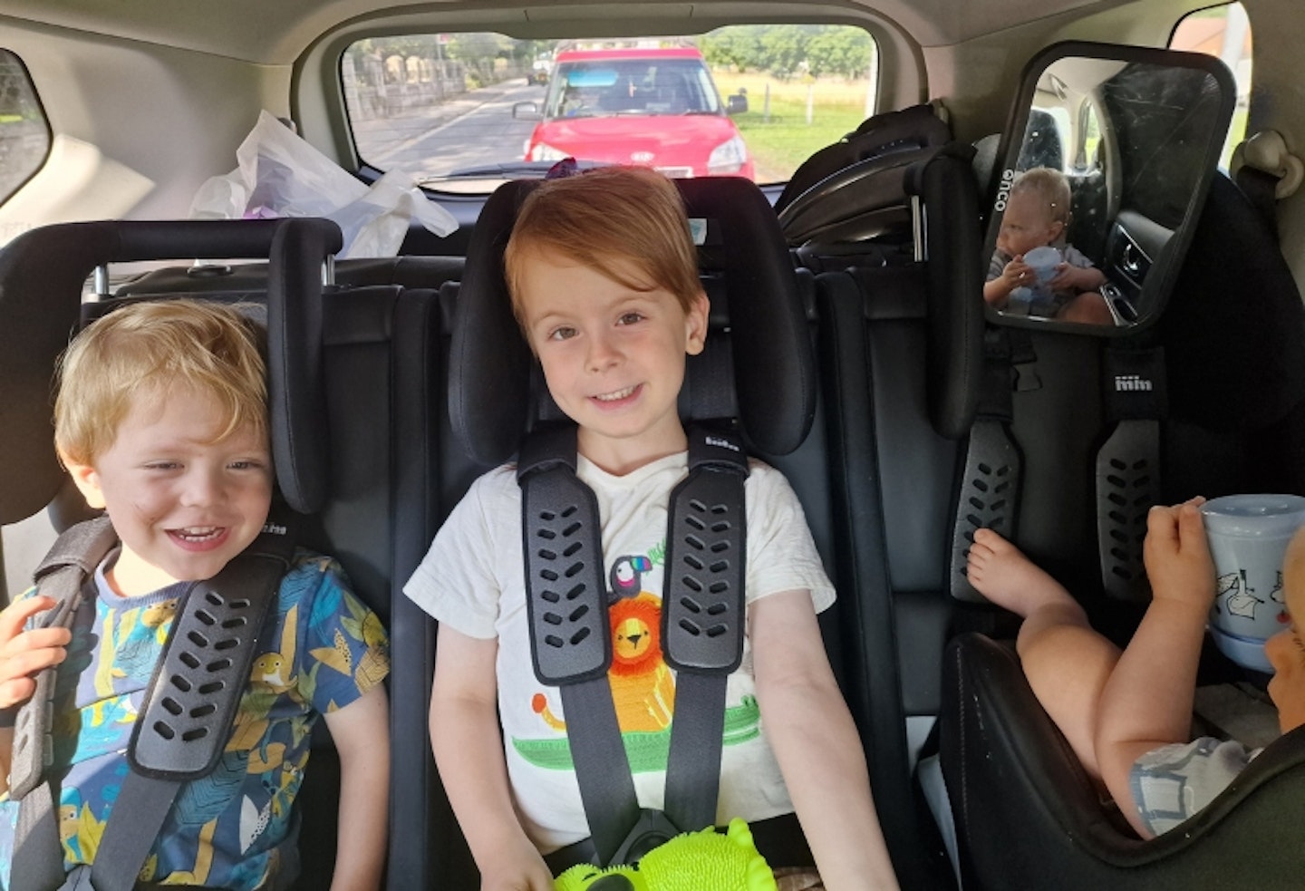 all three young children in the back of a car in the Multimac Three Seater Car Seat, and Minimac