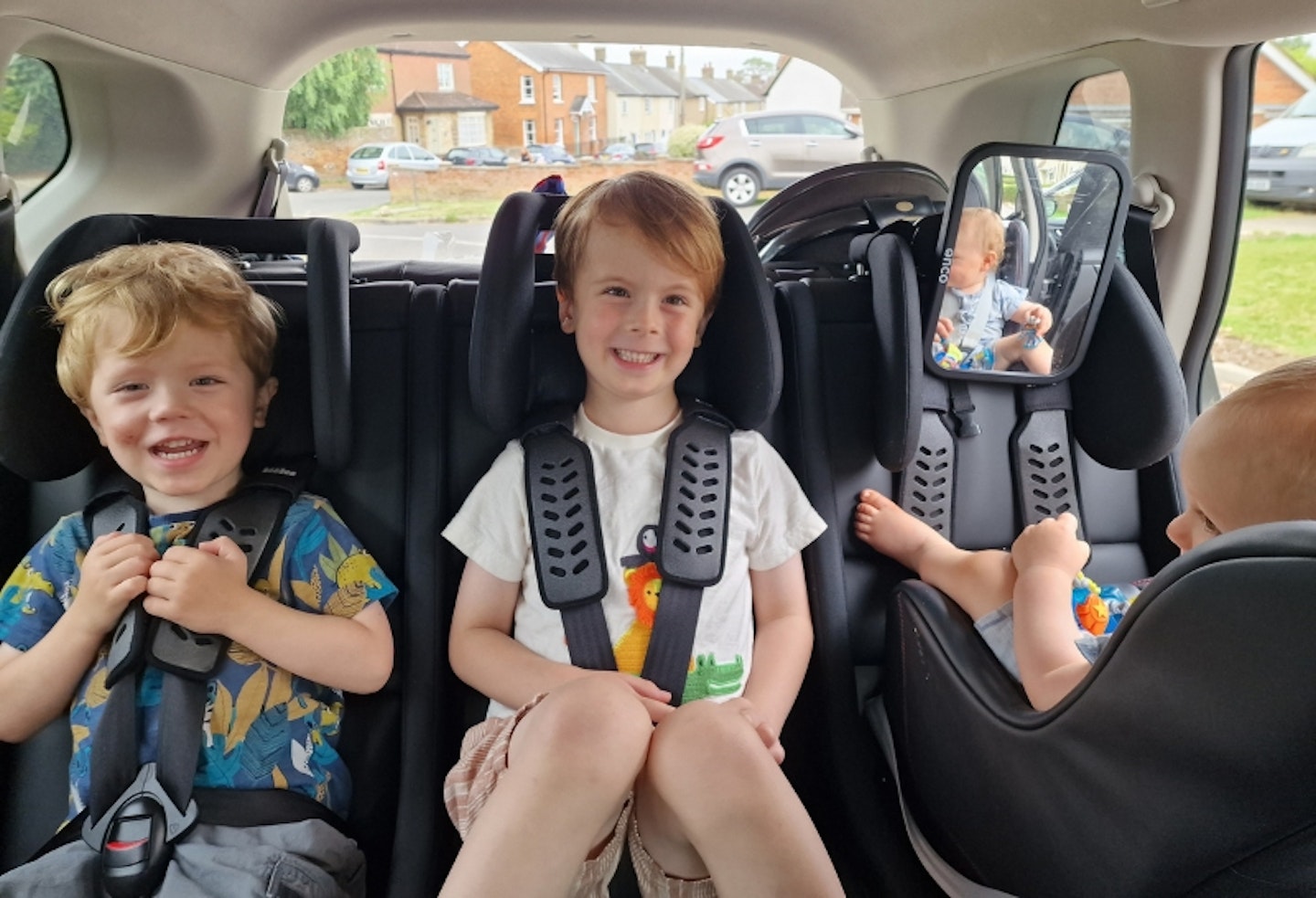 all three young children in the back of a car in the Multimac Three Seater Car Seat, and Minimac