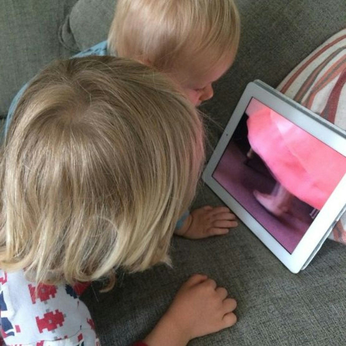 two young children looking at Apple Smart Cover