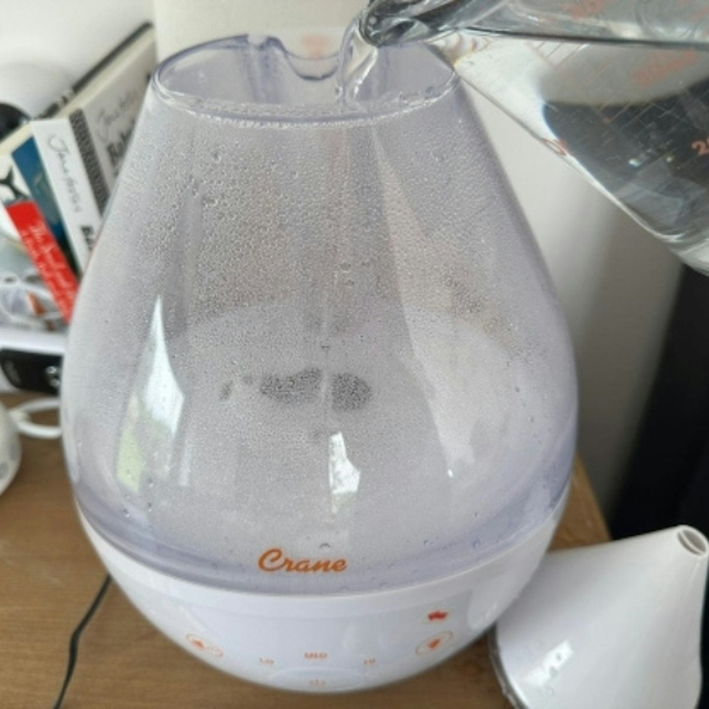 Crane Humidifier with Sound Machine on a table with the cone shaped top removed