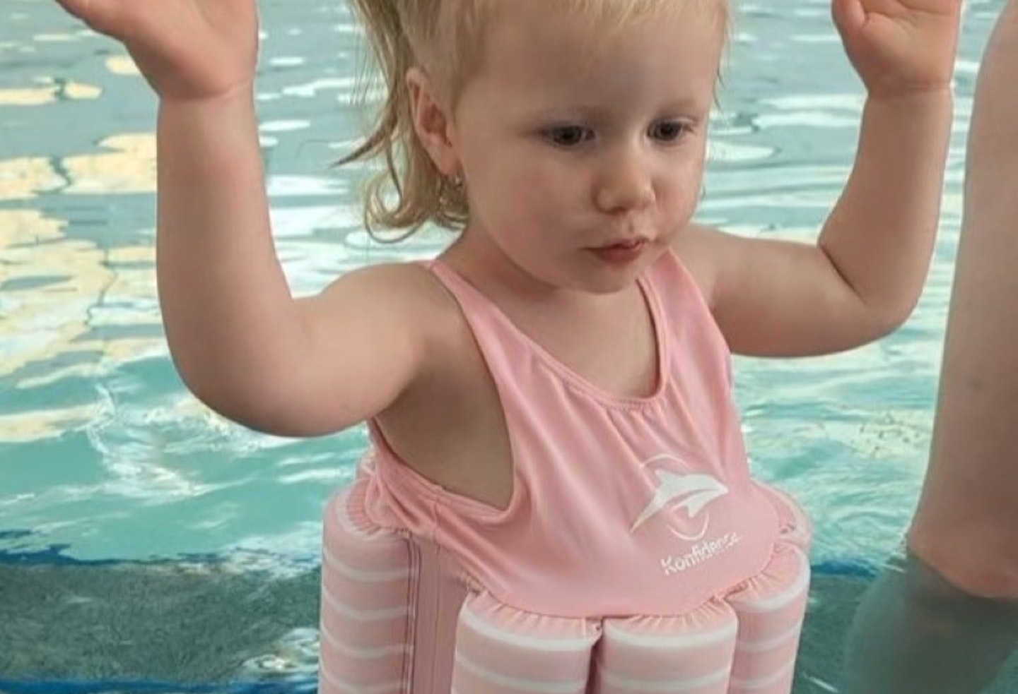 young child wearing the Konfidence Floatsuit at a pool