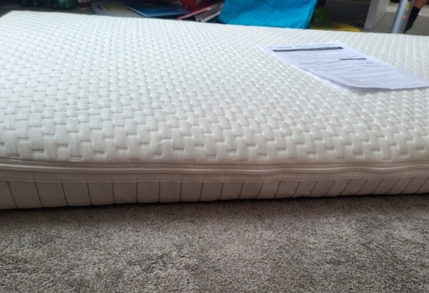 Obaby Moisture Management Dual Core Mattress on the floor, showing the padded pattern