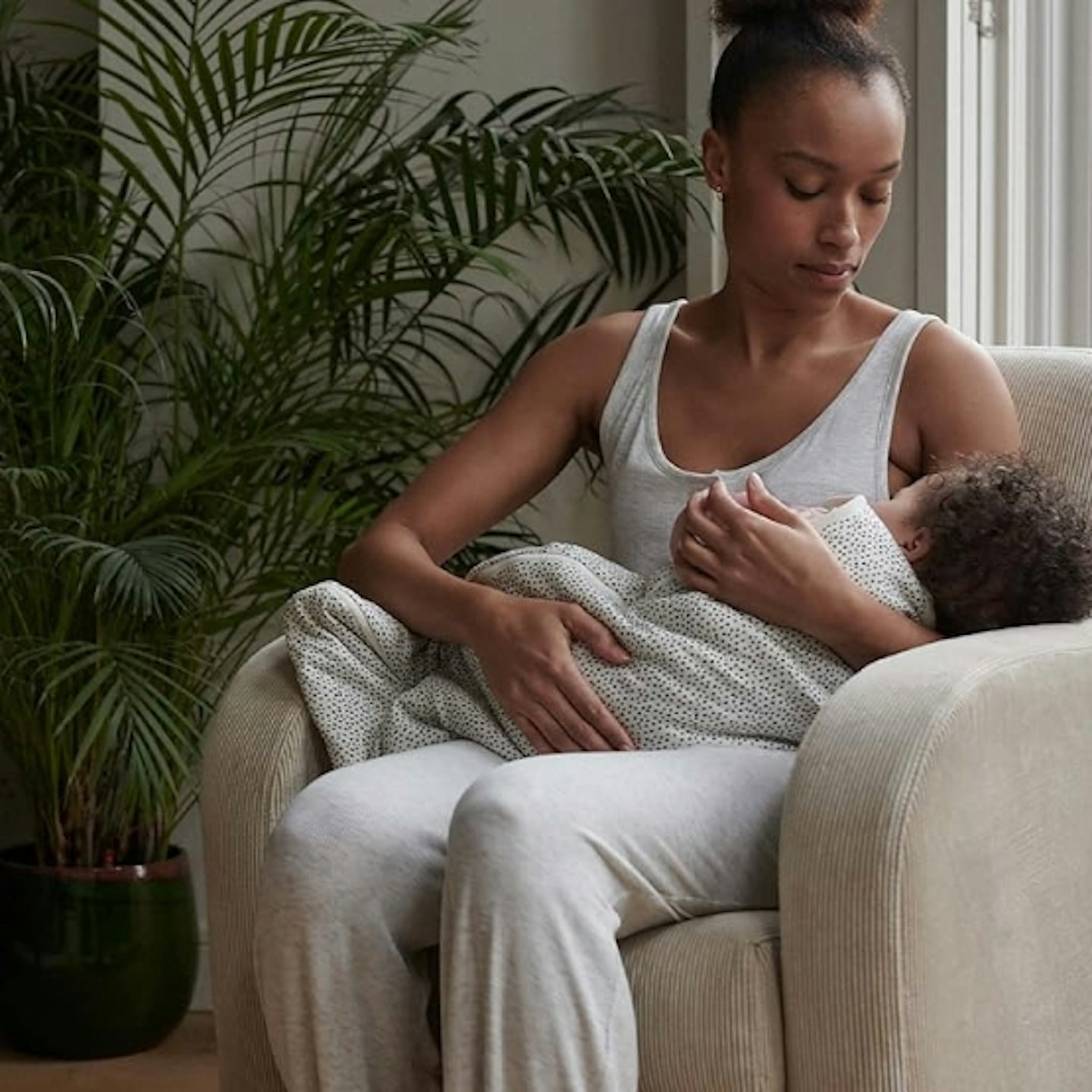 mother holding a baby in the Cuddleo Etta Rocker