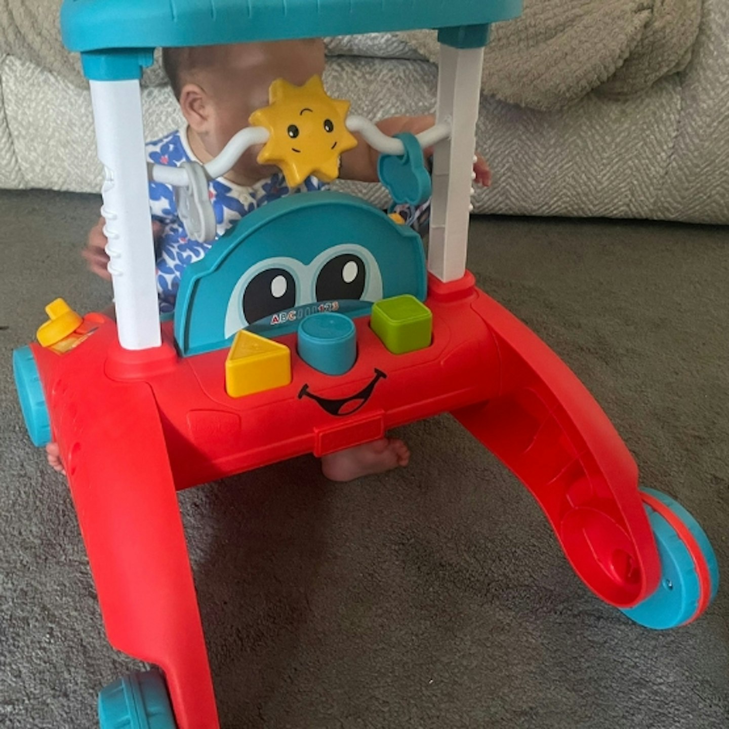 baby playing with Fisher-Price 2-sided steady speed walker