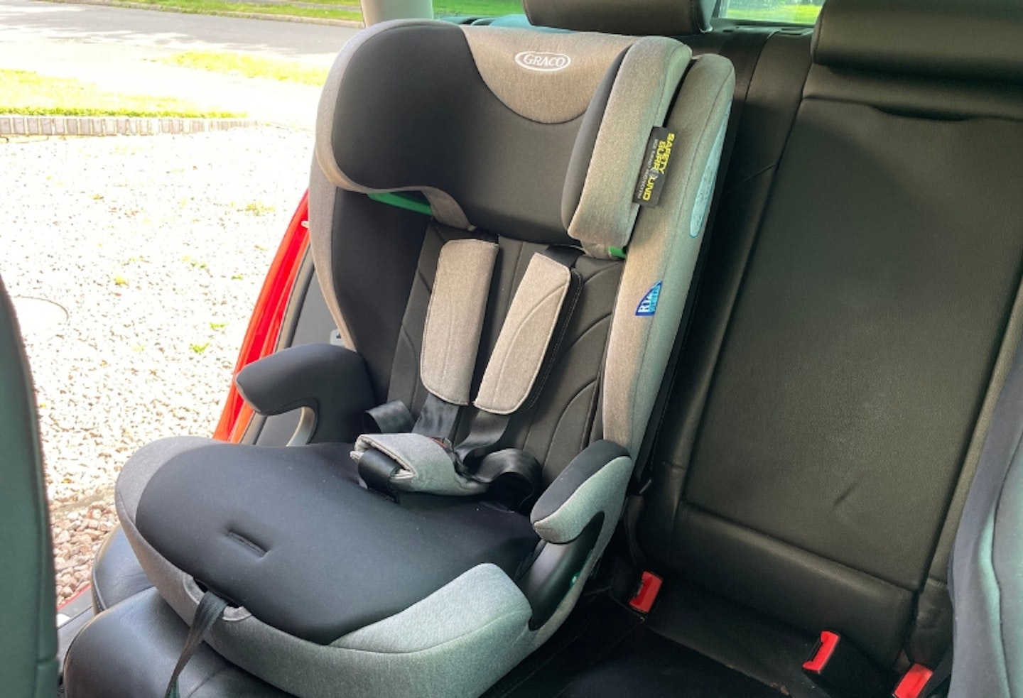 Graco Energi without top headrest on, installed in the back of a car