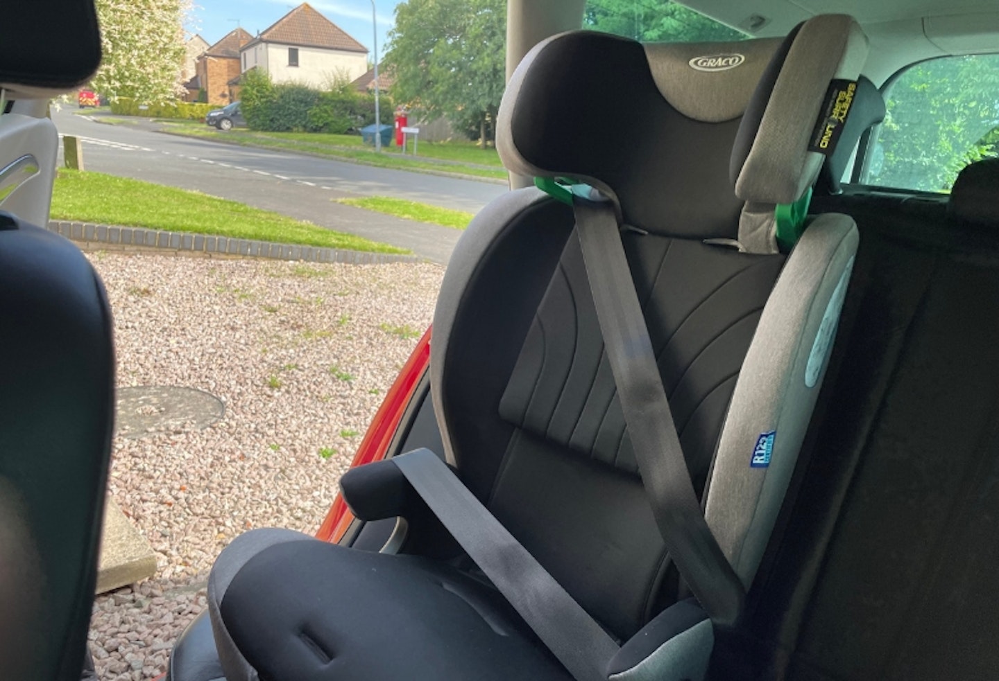 Graco Energi with top headrest on, installed in the back of a car