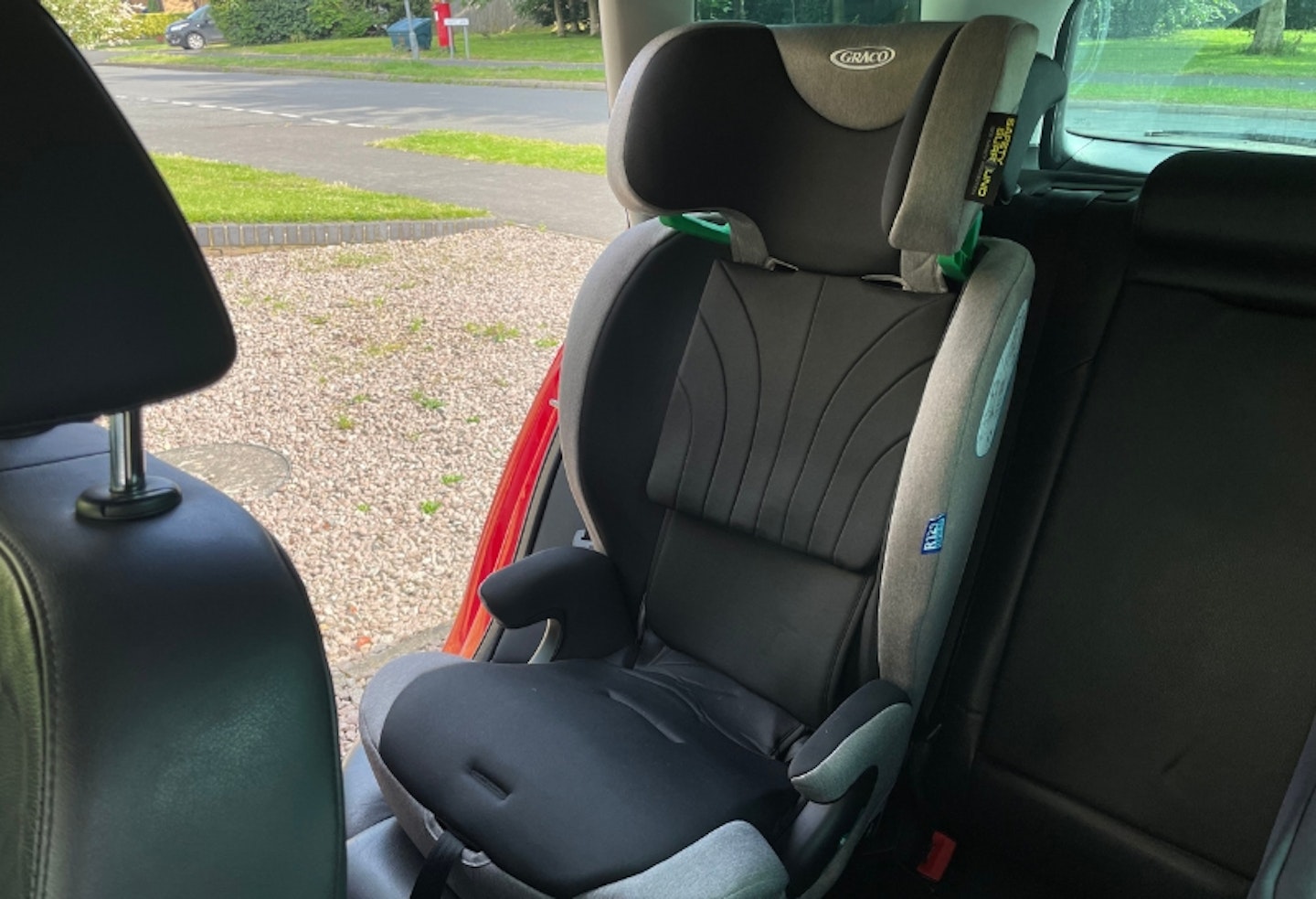 Graco Energi with top headrest on, installed in the back of a car