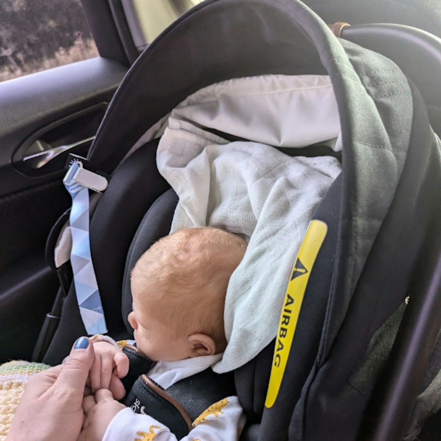 baby strapped in to the Joie Sprint car seat in the car