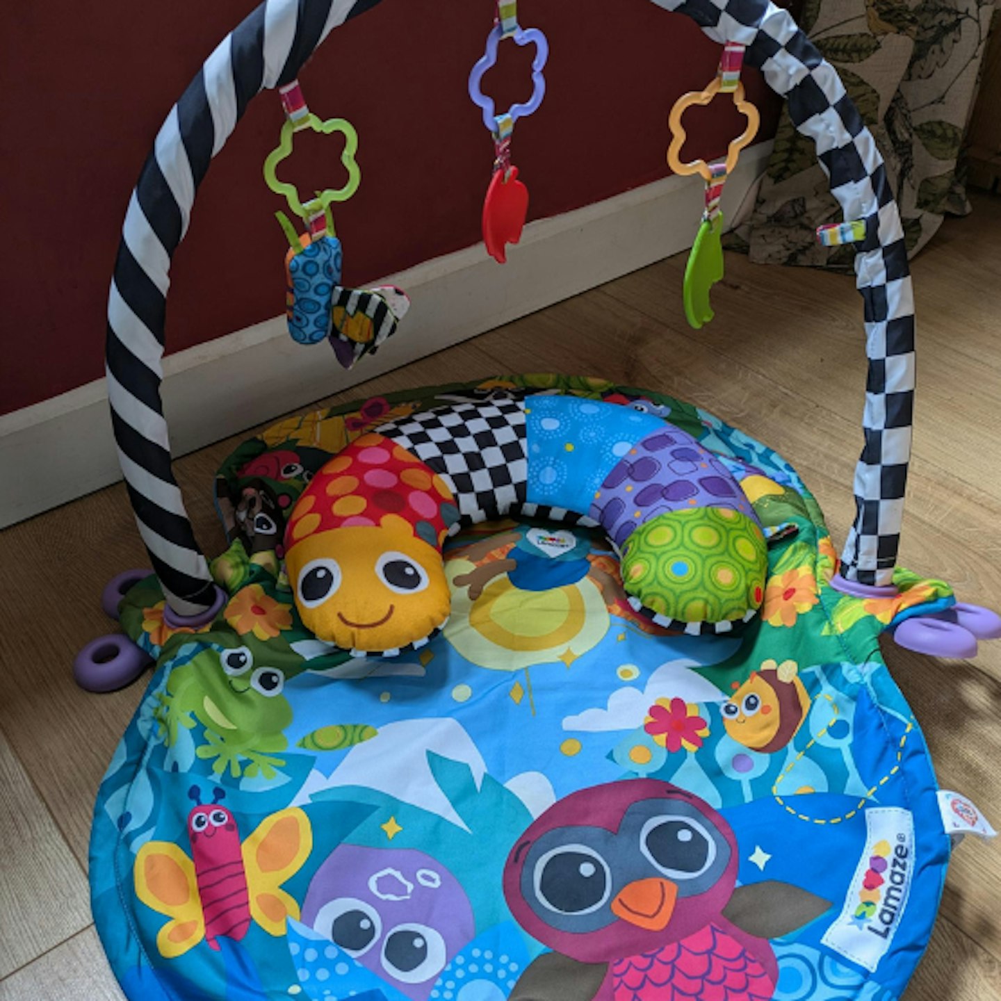 Colourful and high contrast baby play mat and activity play gym by LAMAZE with pillow and hanging toys