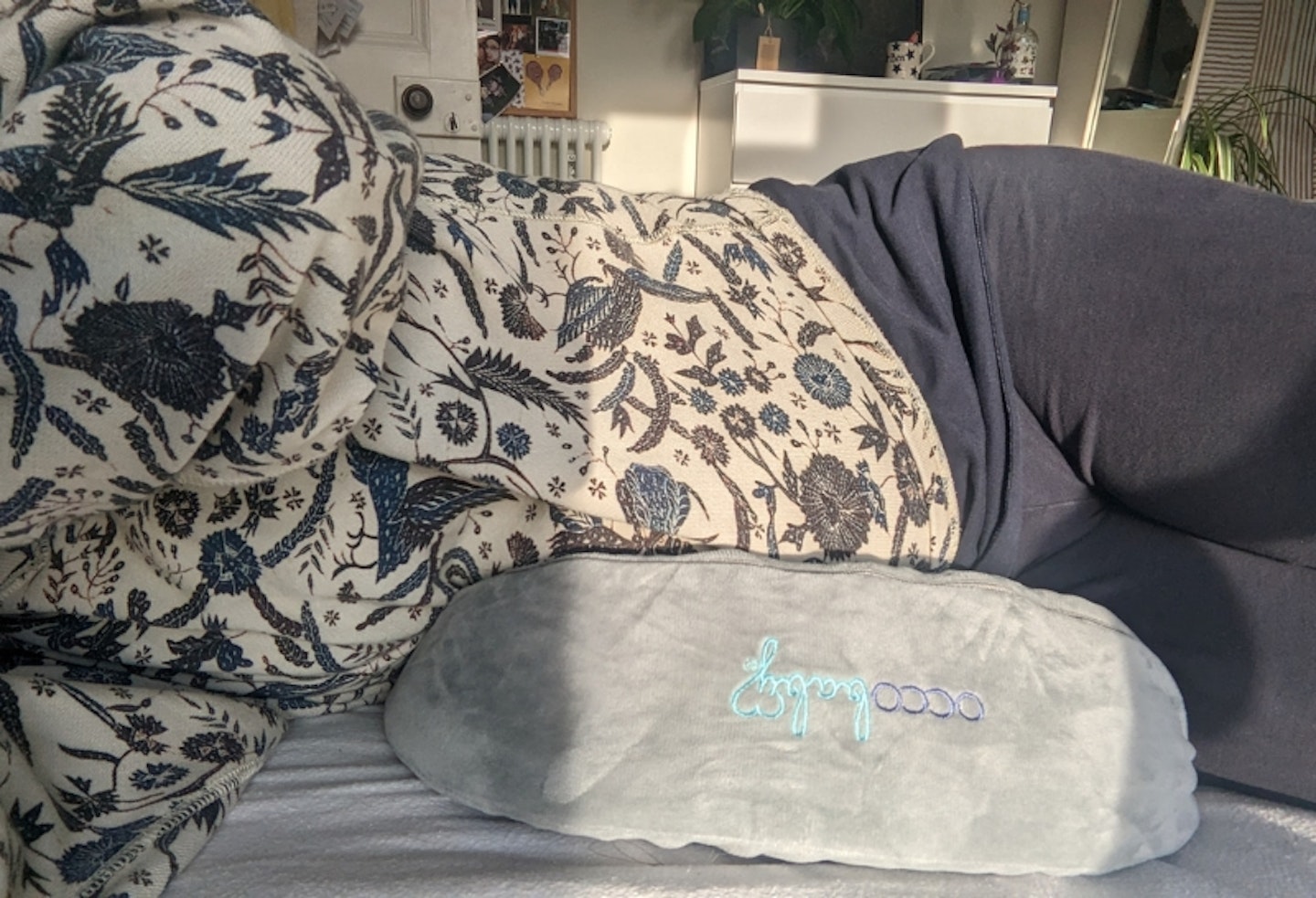 woman laying on her side on the OCCObaby Pregnancy Wedge Pillow for Sleeping