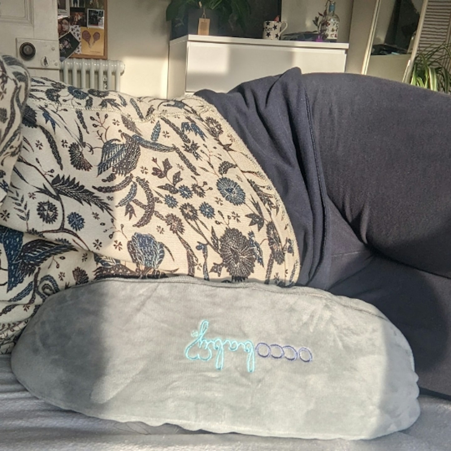 woman laying on her side on the OCCObaby Pregnancy Wedge Pillow for Sleeping