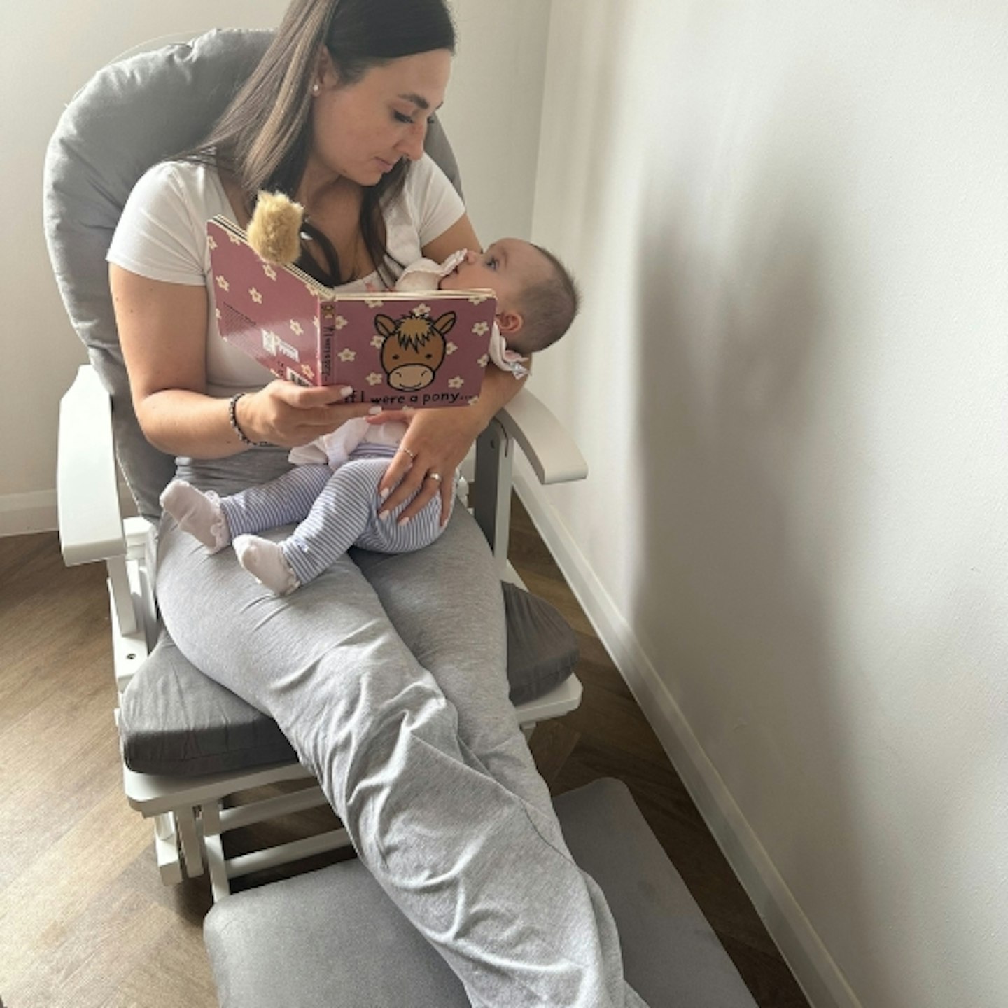 mother and baby on the Obaby Reclining Glider Nursing Chair in their home