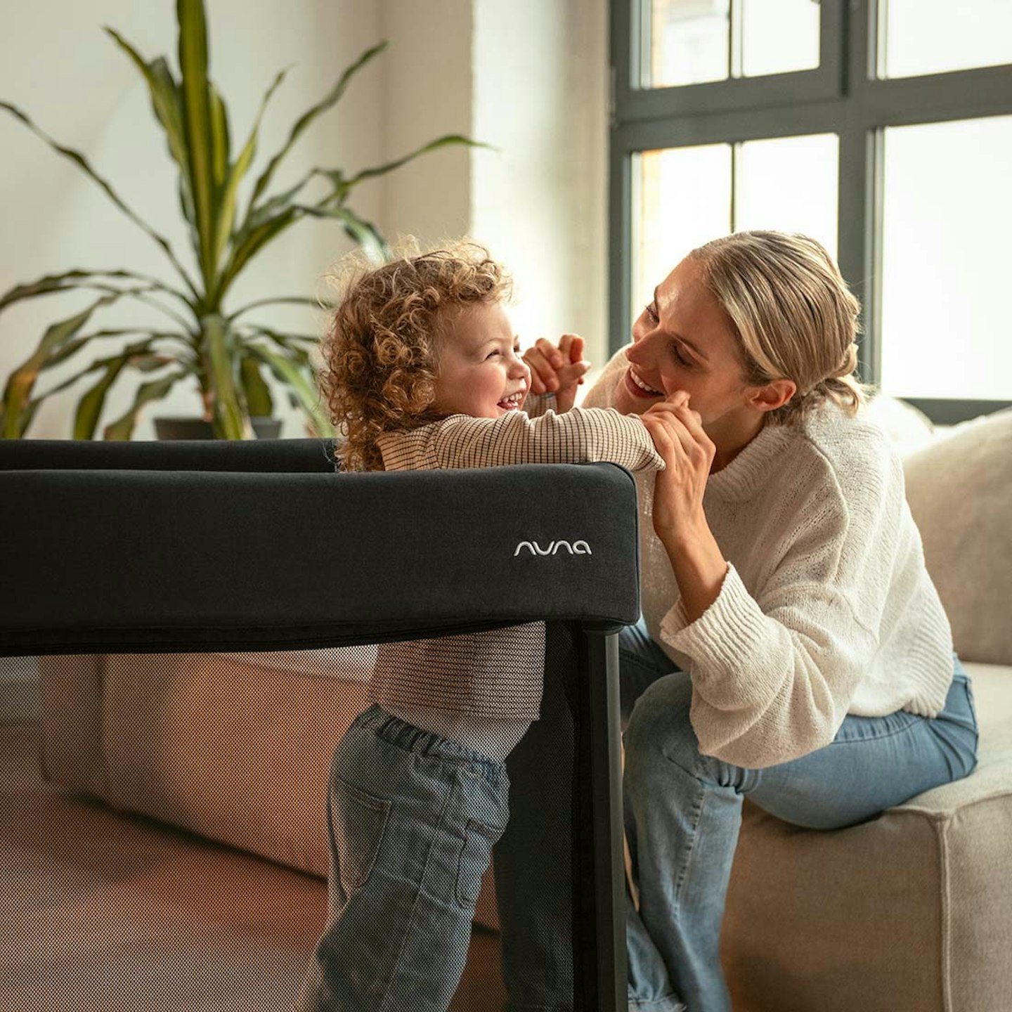 Mum and baby in Nuna PAAL travel cot